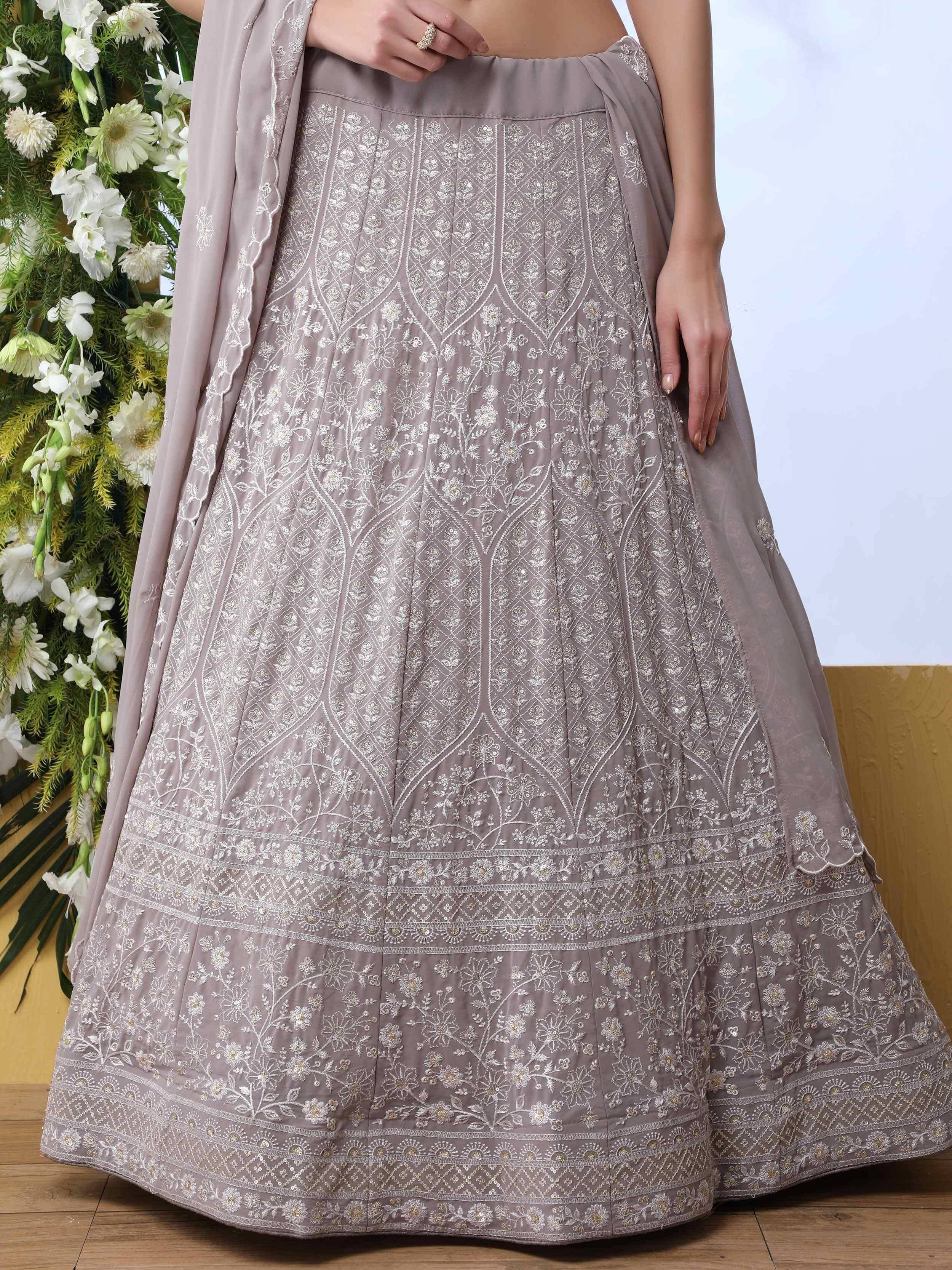 Elegant grey lehenga with intricate white floral embroidery, perfect for Indian ethnic wear occasions.