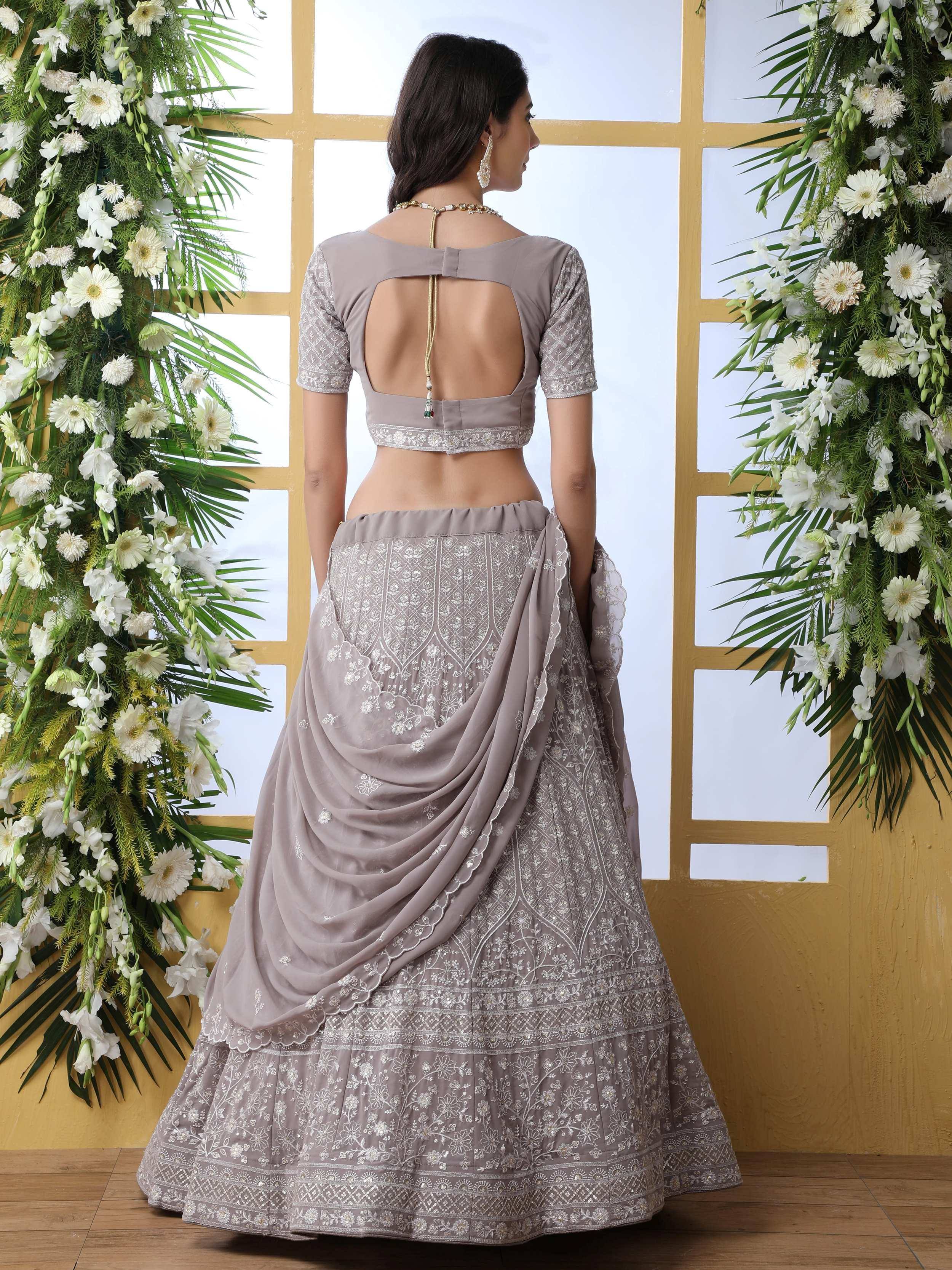 Elegant grey lehenga choli with intricate embroidery and open back design
