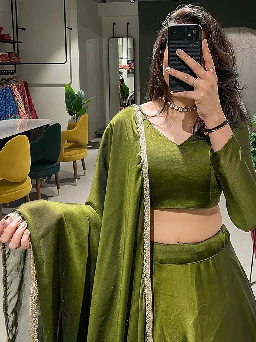Olive green velvet lehenga choli with gold trim, perfect for Indian ethnic wear occasions.