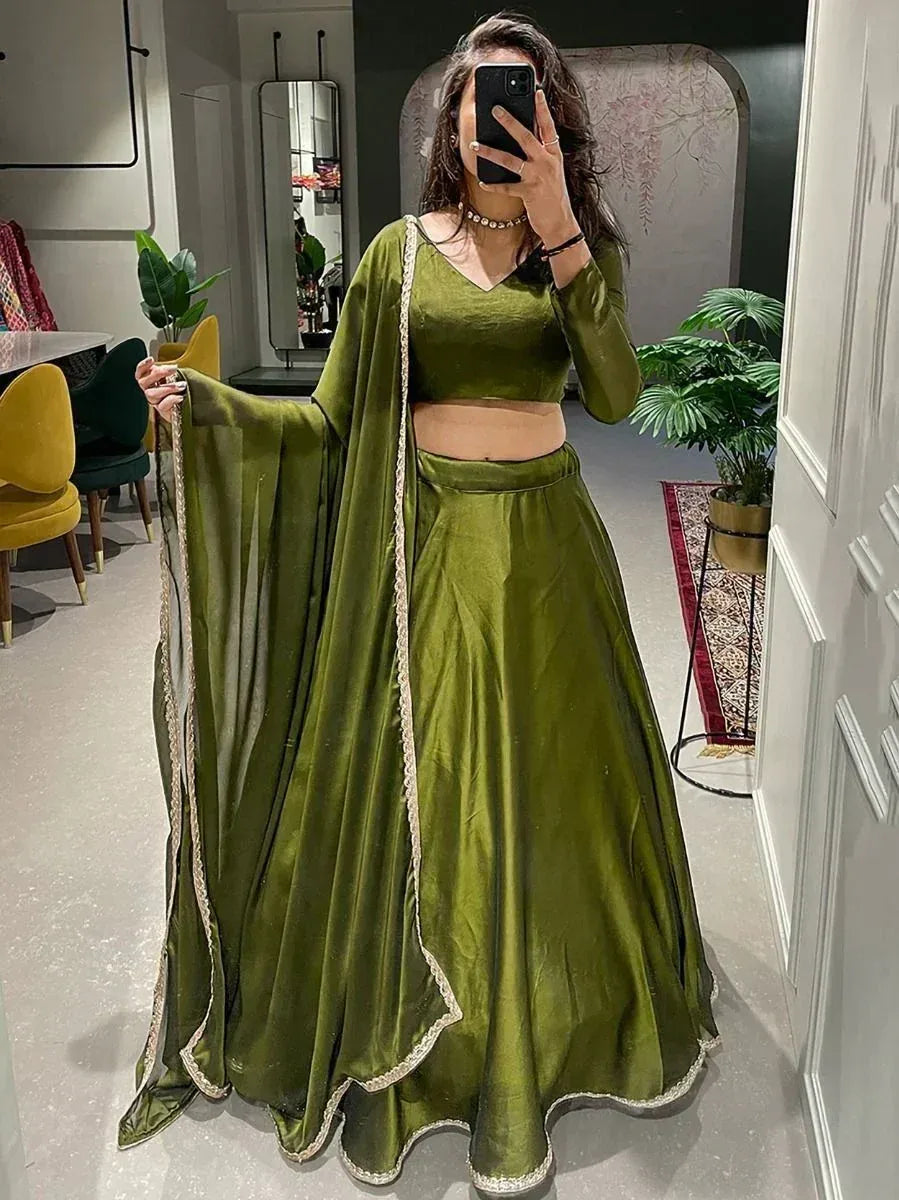 Olive green velvet lehenga choli with gold trim, perfect for Indian ethnic wear and festive occasions.