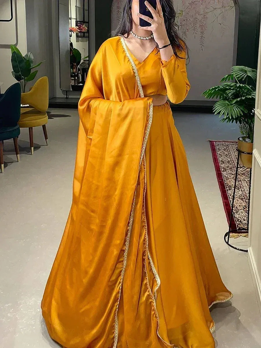 Mustard yellow satin lehenga choli with gold trim, elegant Indian ethnic wear for women