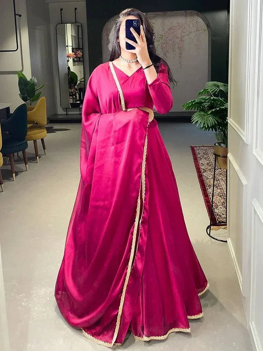 Pink velvet ethnic gown with gold trim, perfect for Indian weddings and festive occasions