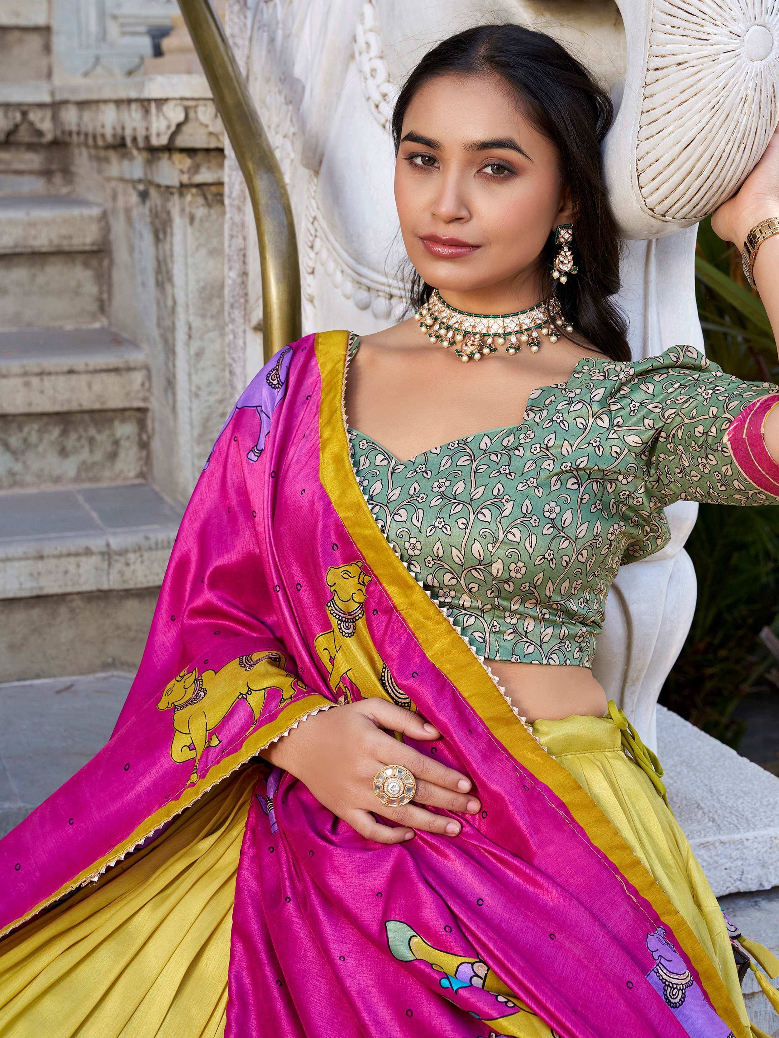 Woman in vibrant pink and green printed saree with floral blouse, traditional Indian ethnic wear