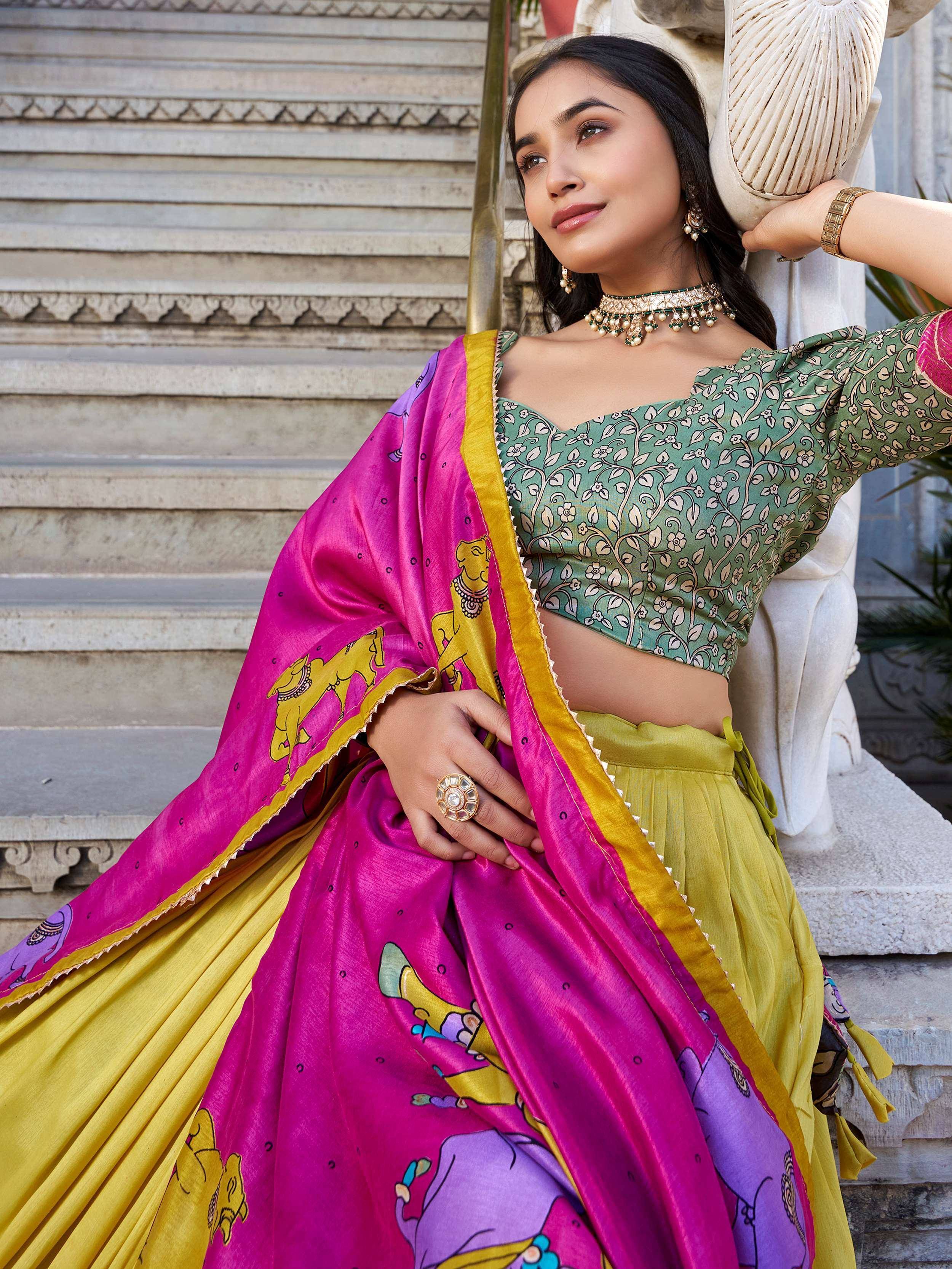 Woman in vibrant pink and yellow printed lehenga choli with green floral blouse, traditional Indian ethnic wear