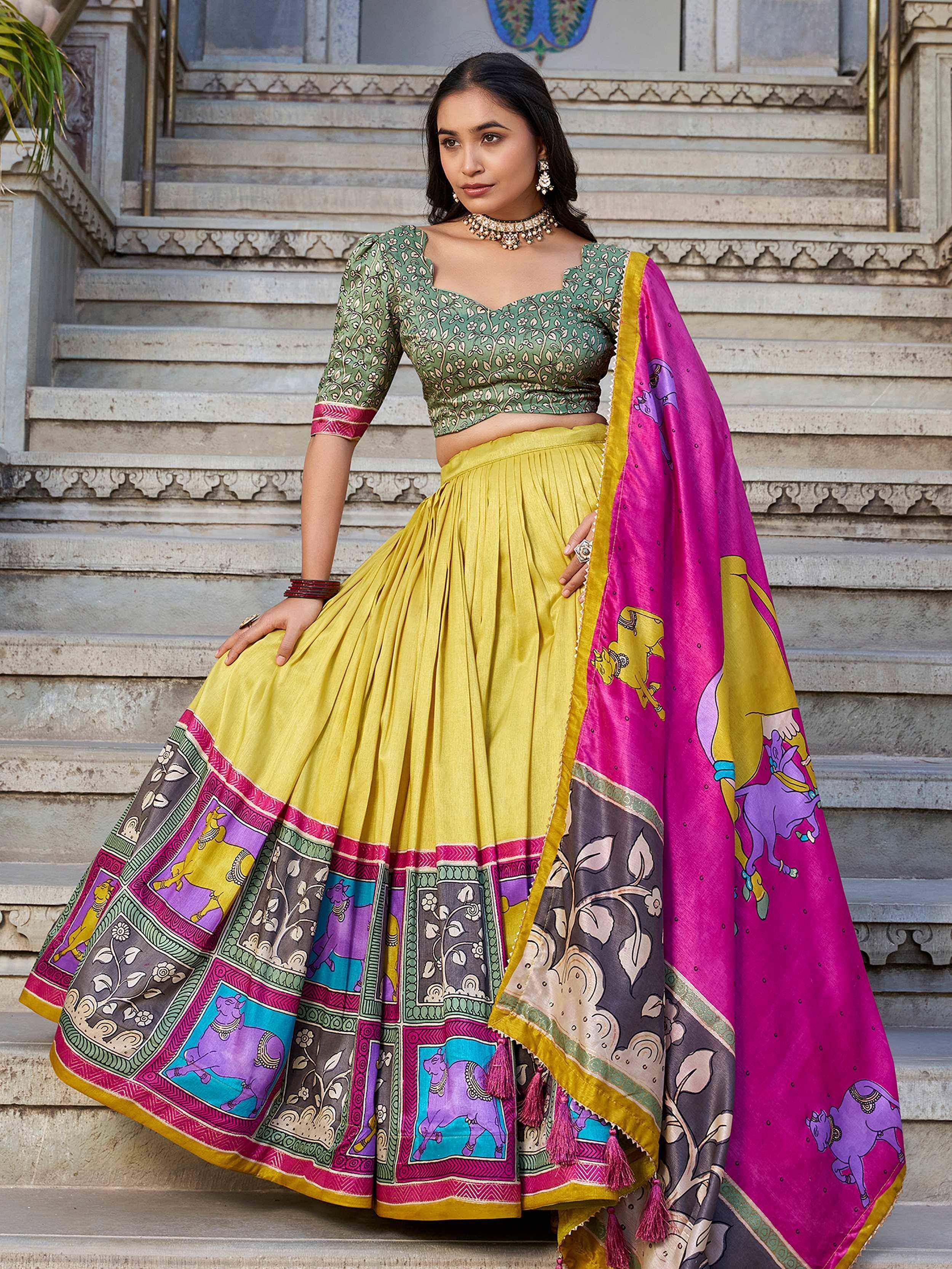 Green printed blouse with yellow pleated lehenga and pink dupatta, ethnic Indian wear for women