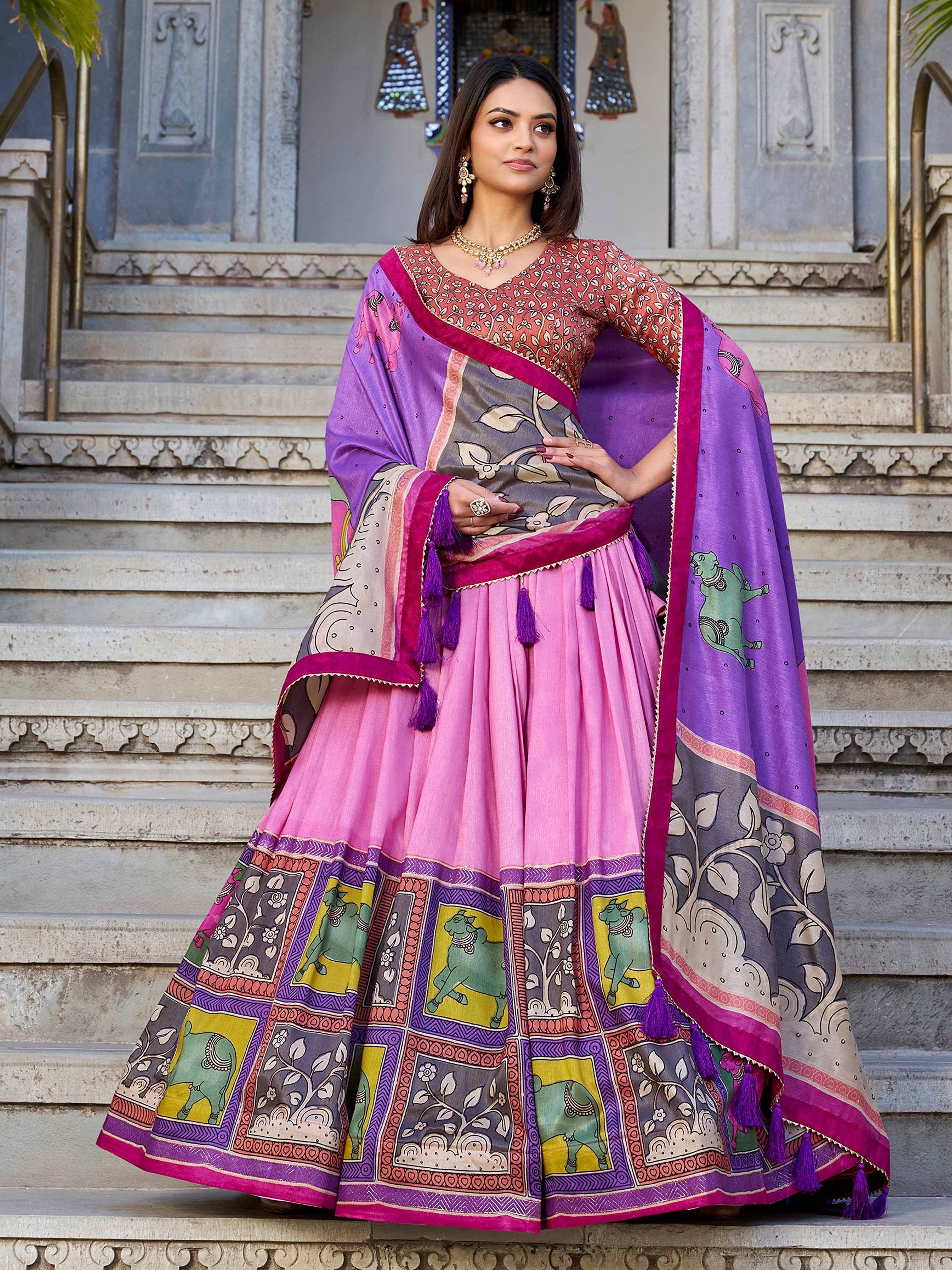 Woman in vibrant pink and purple printed lehenga choli with elephant motifs, perfect for Indian ethnic occasions