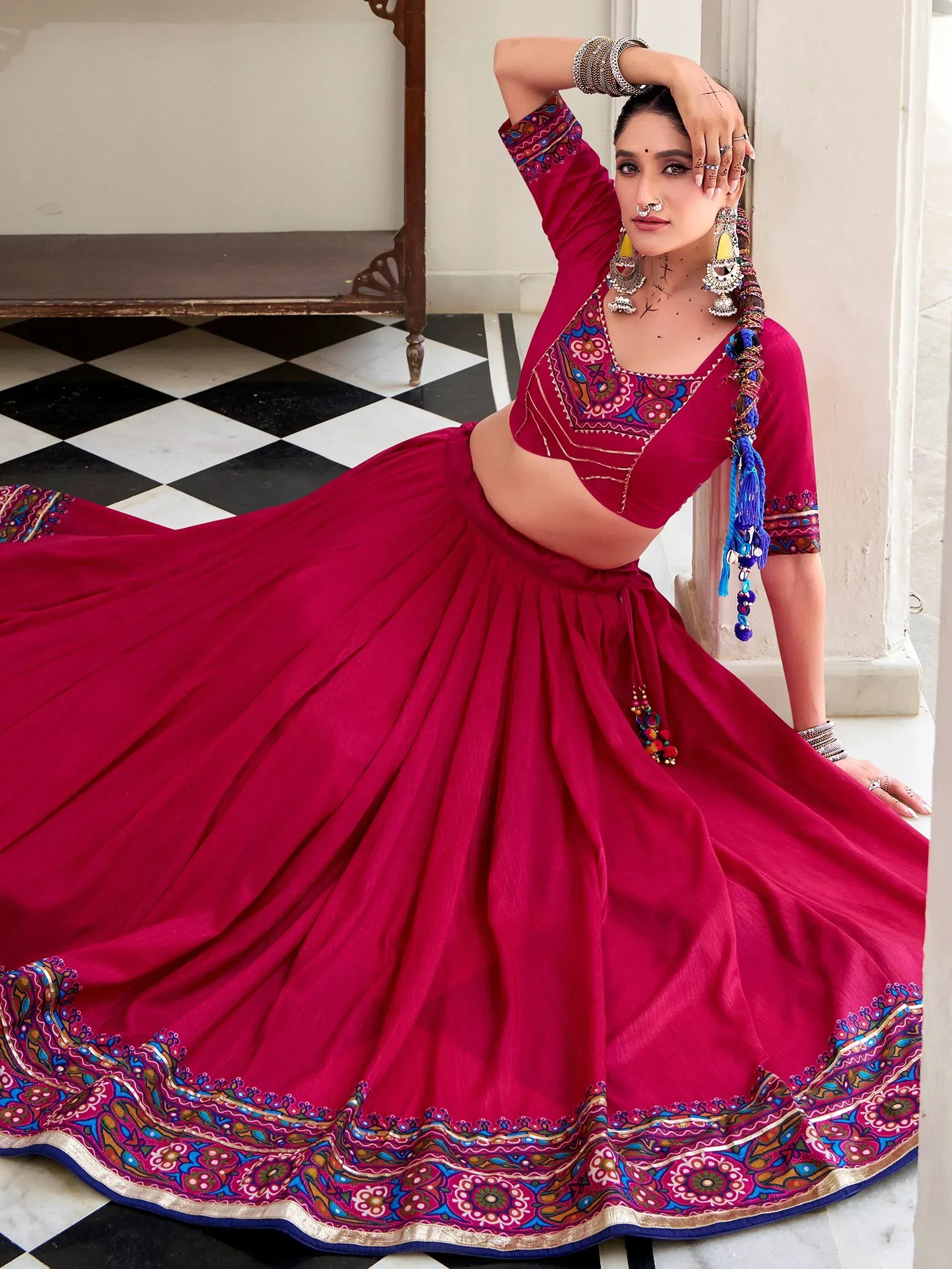 Vibrant red ethnic lehenga choli with intricate embroidery, perfect for Indian weddings and festive occasions.