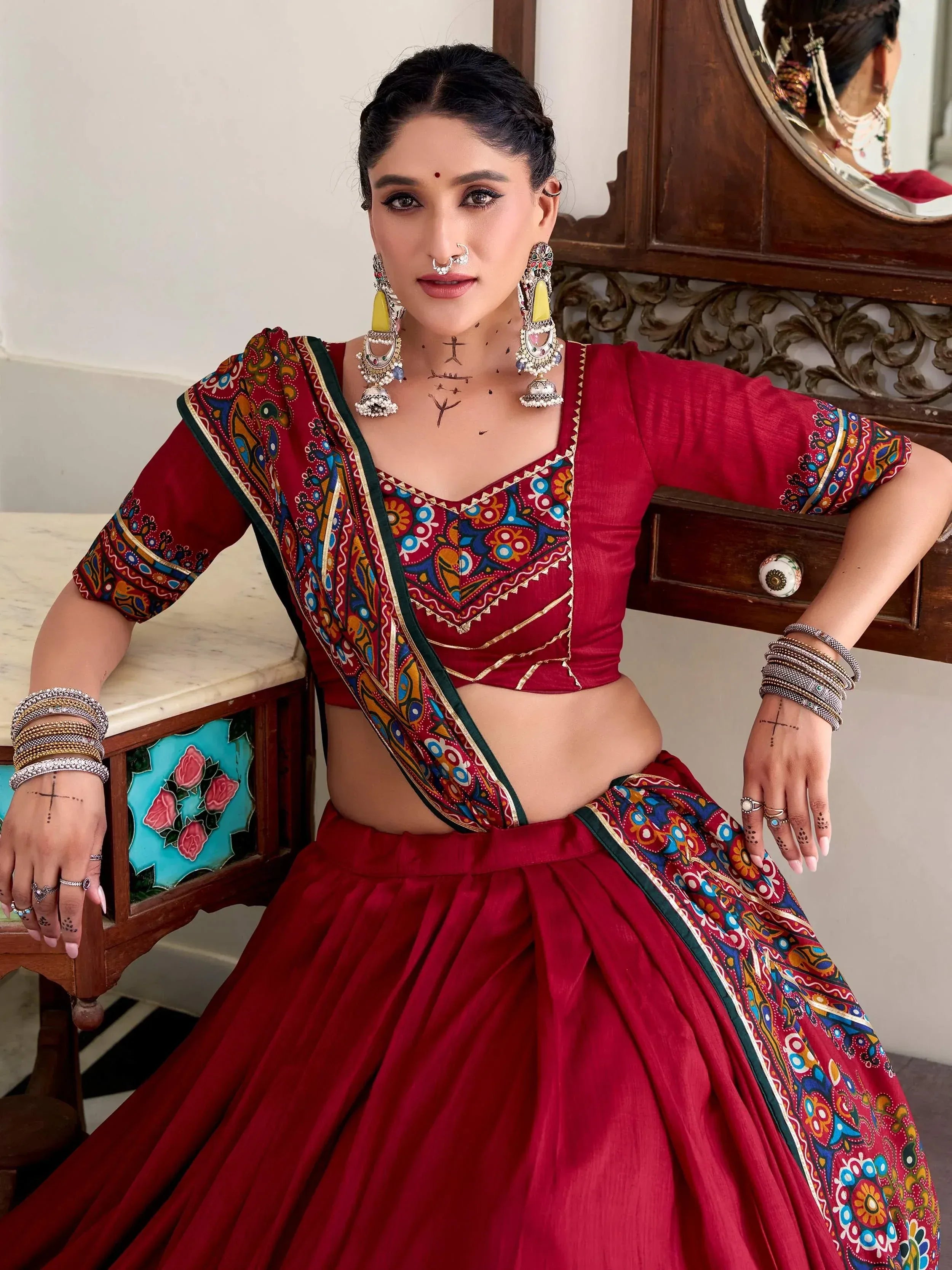 Red ethnic lehenga choli with colorful printed dupatta, traditional Indian wear for women