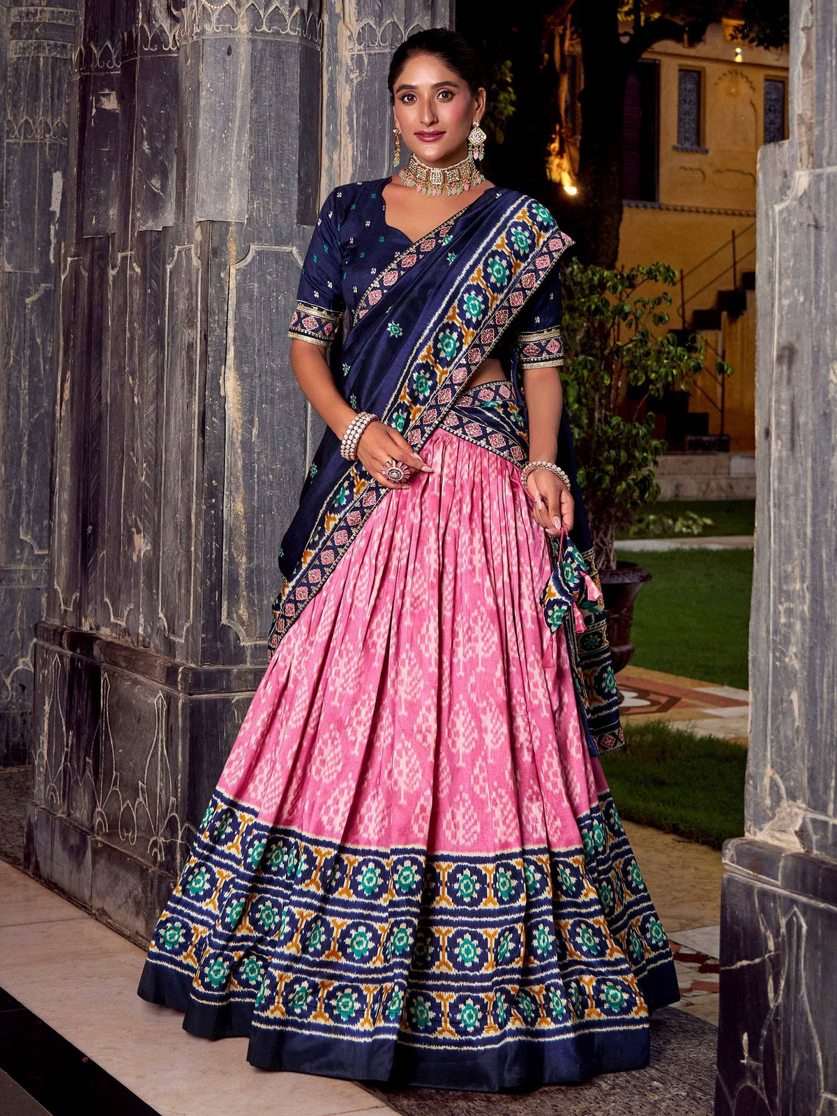 Pink and navy blue designer lehenga choli with intricate embroidery, perfect for Indian ethnic wear occasions.