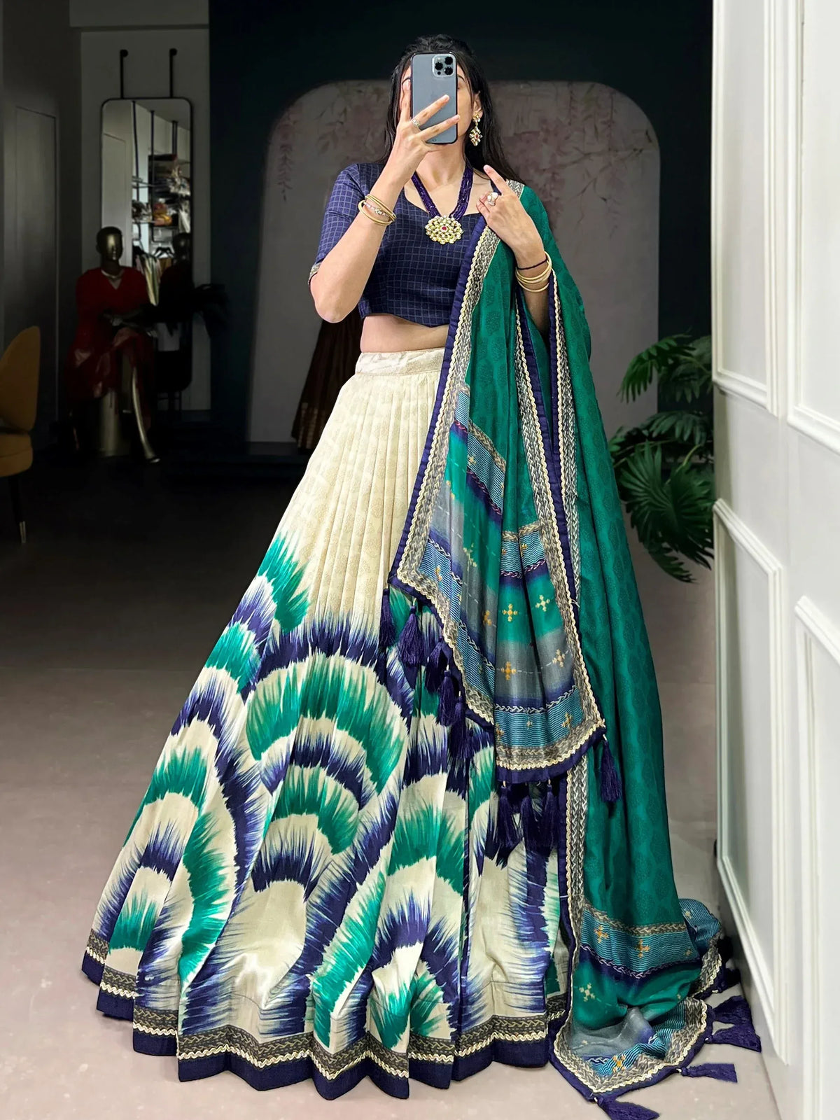 Elegant green and blue ikat lehenga choli with intricate embroidery and matching dupatta
