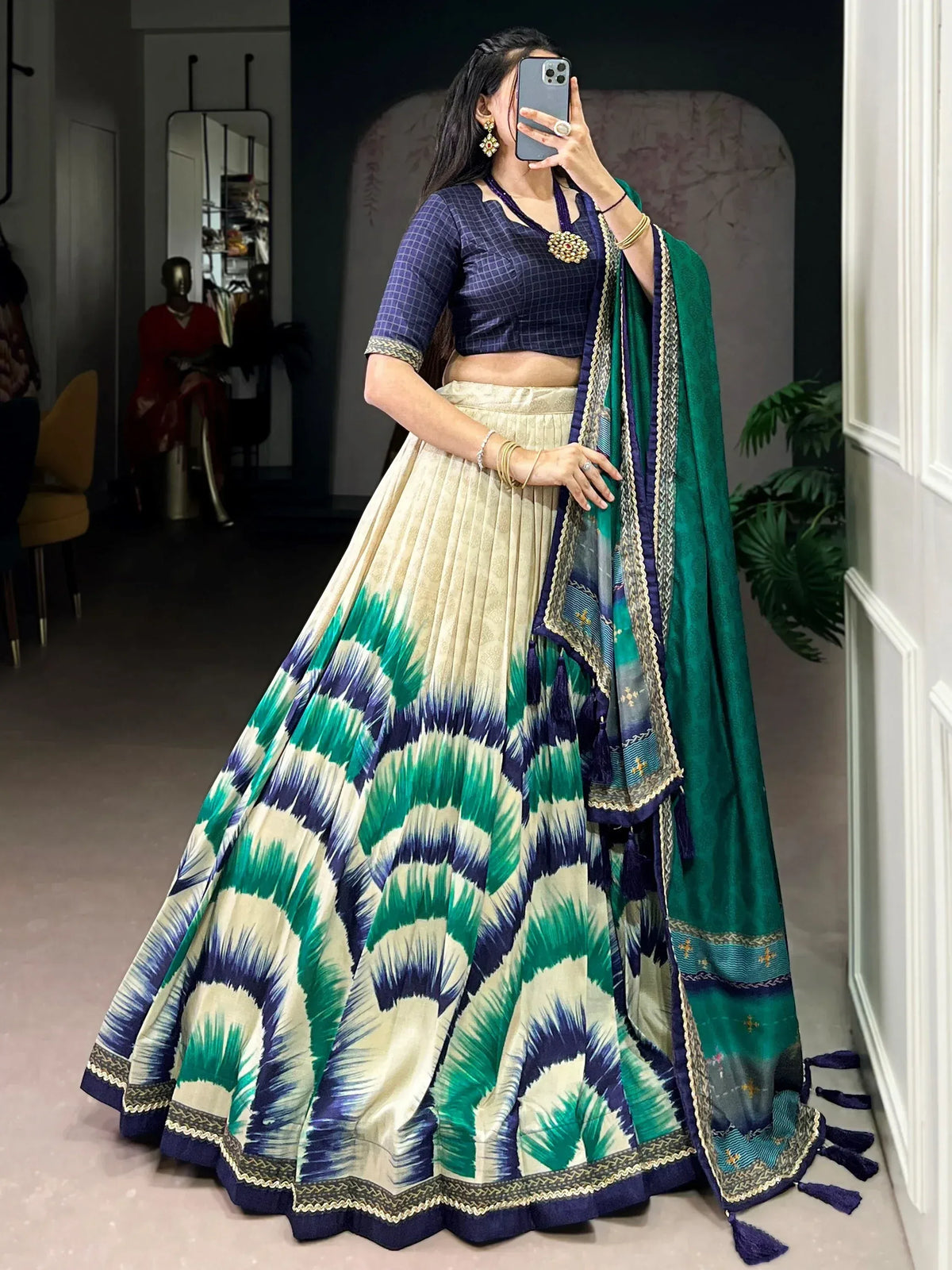 Woman in elegant Indian lehenga choli with green and blue ikat print, perfect for ethnic occasions