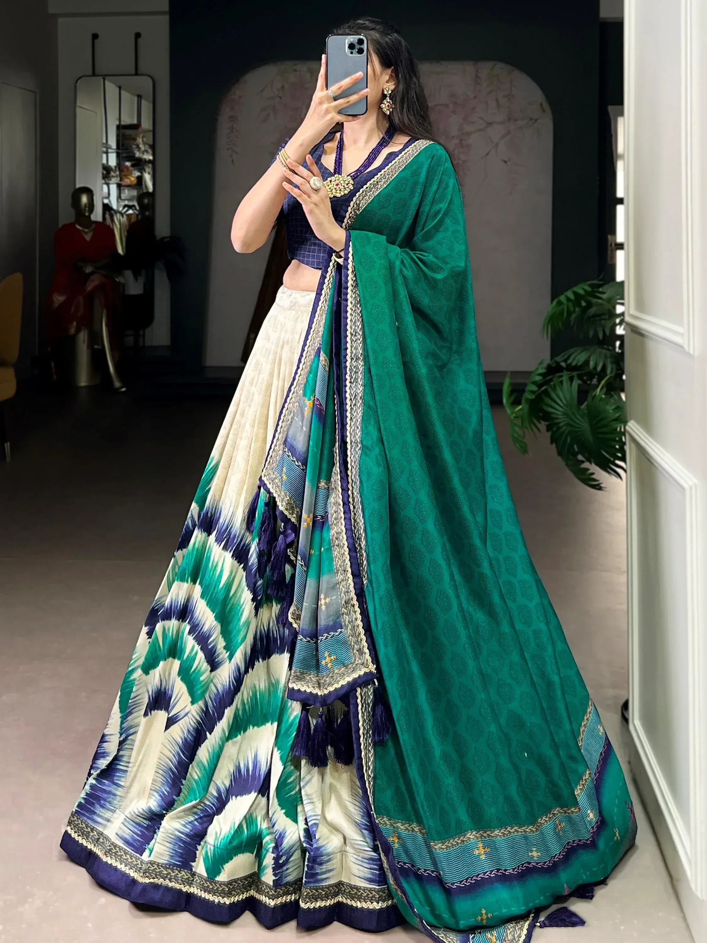 Elegant green and blue printed lehenga choli with intricate borders, perfect for Indian ethnic wear.