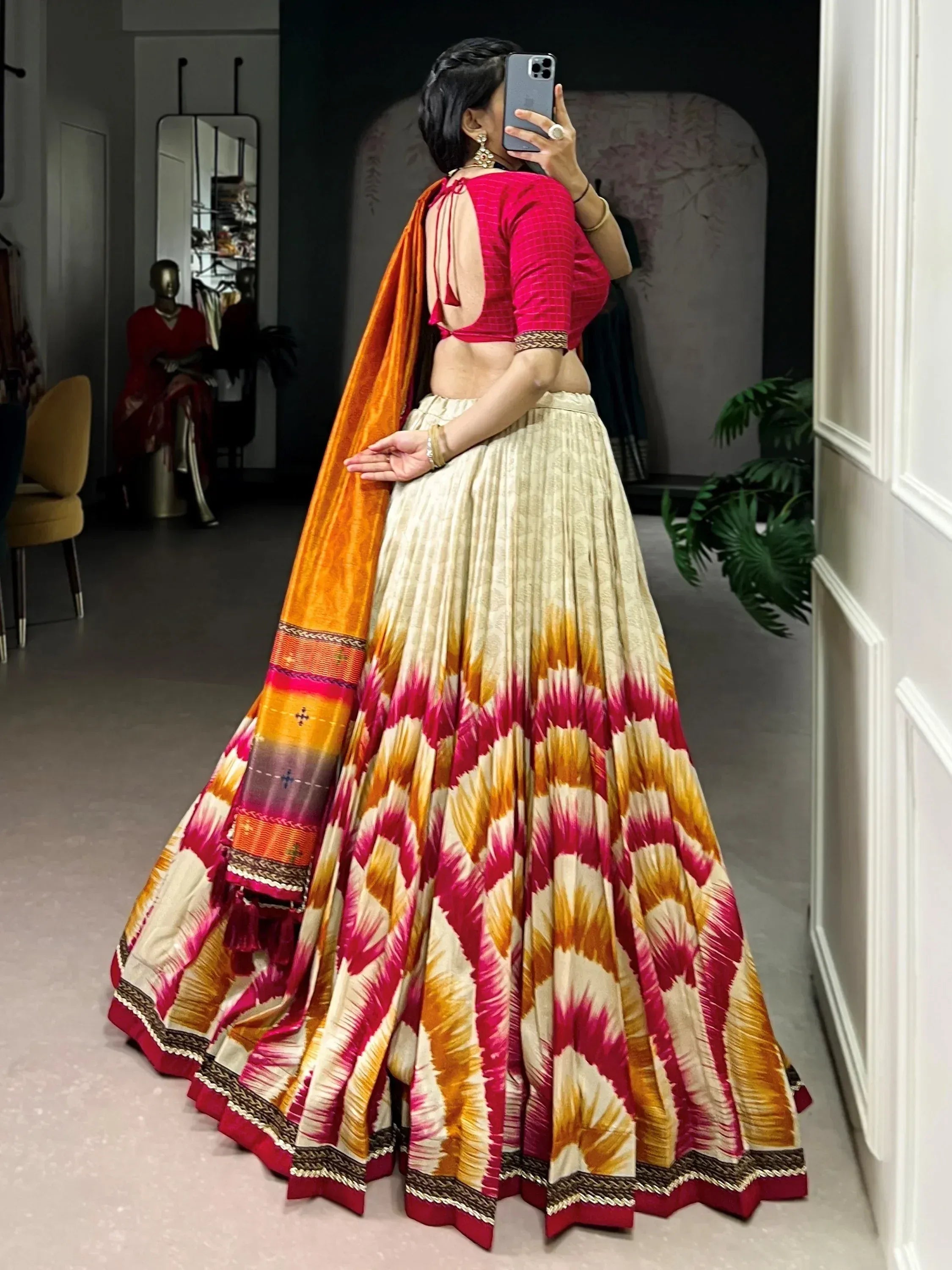Vibrant ikat print lehenga choli with orange dupatta, perfect for Indian ethnic wear