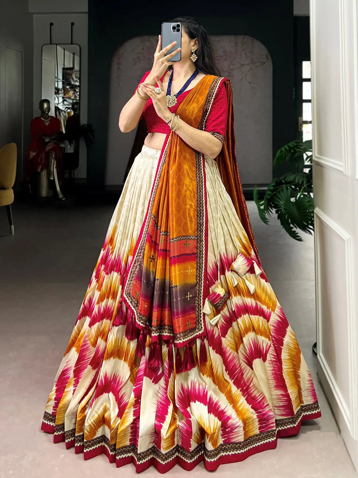 Vibrant pink and orange lehenga choli with ikat print, perfect for Indian ethnic wear and festive occasions.