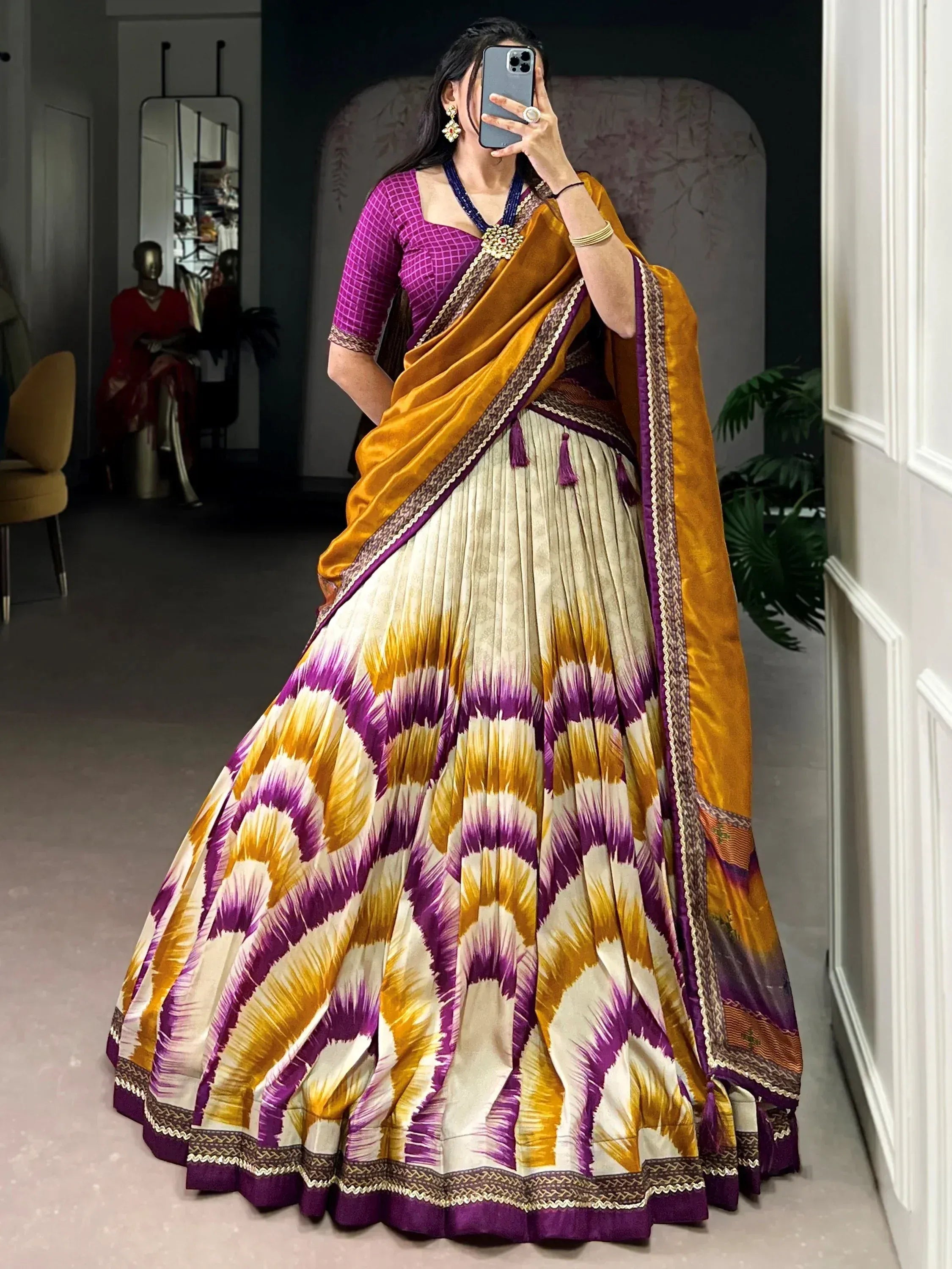 Woman in vibrant purple and gold ikat print lehenga choli with velvet dupatta, perfect for Indian ethnic wear occasions.