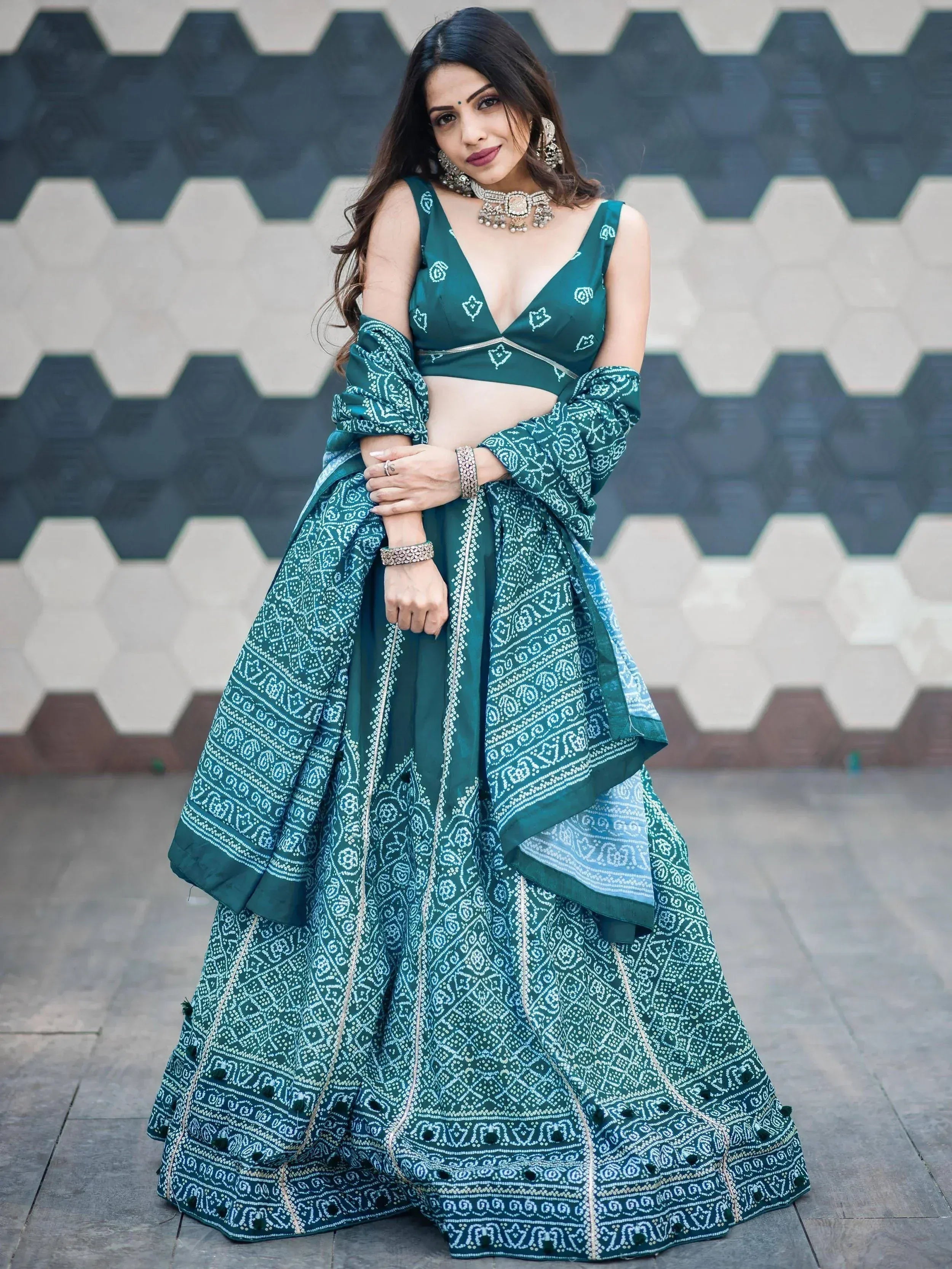Emerald green printed lehenga choli with V-neck blouse and flared skirt, perfect for Indian ethnic wear occasions.