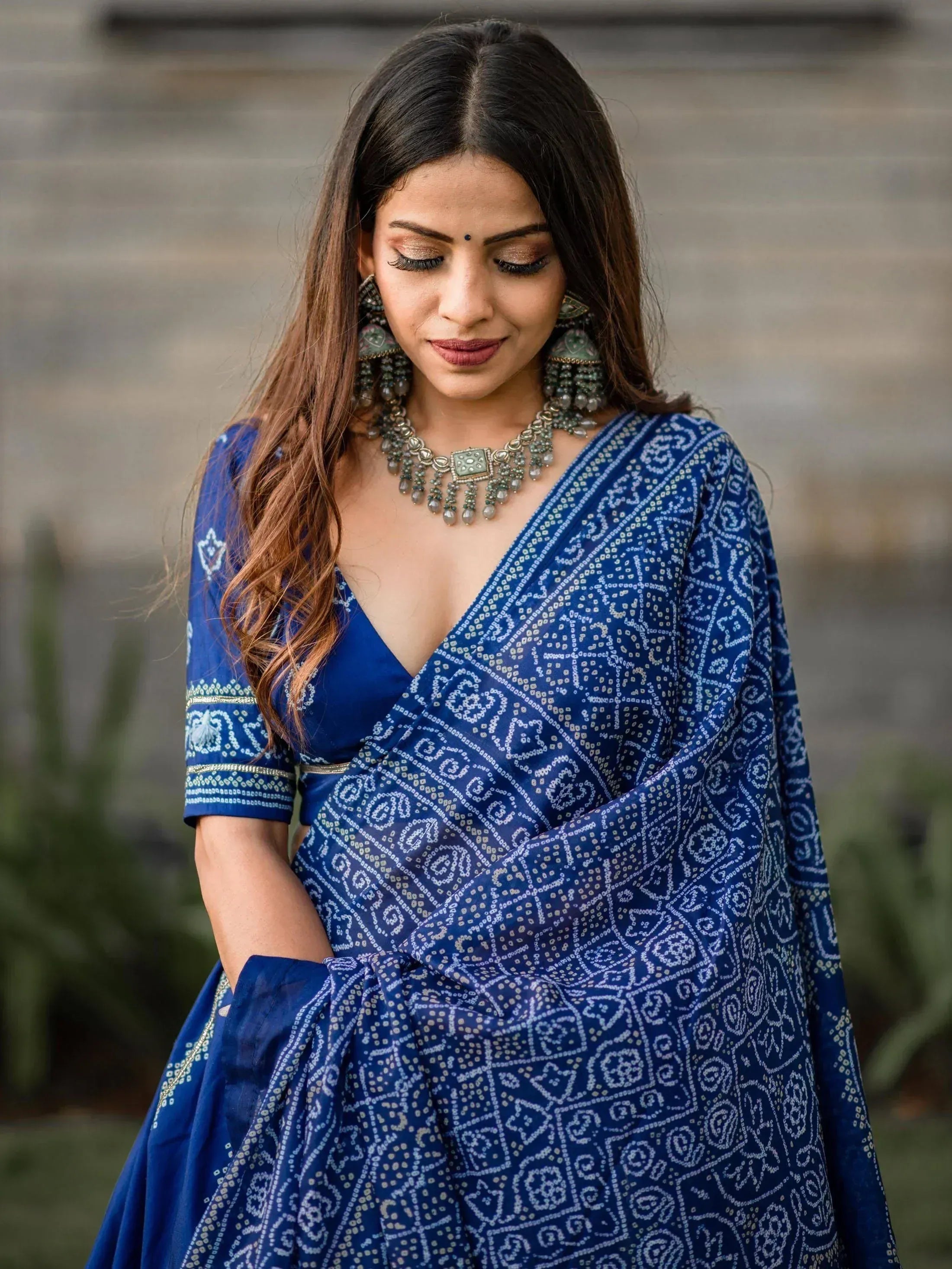 Blue printed ethnic gown with V-neck and matching jewelry for Indian wear