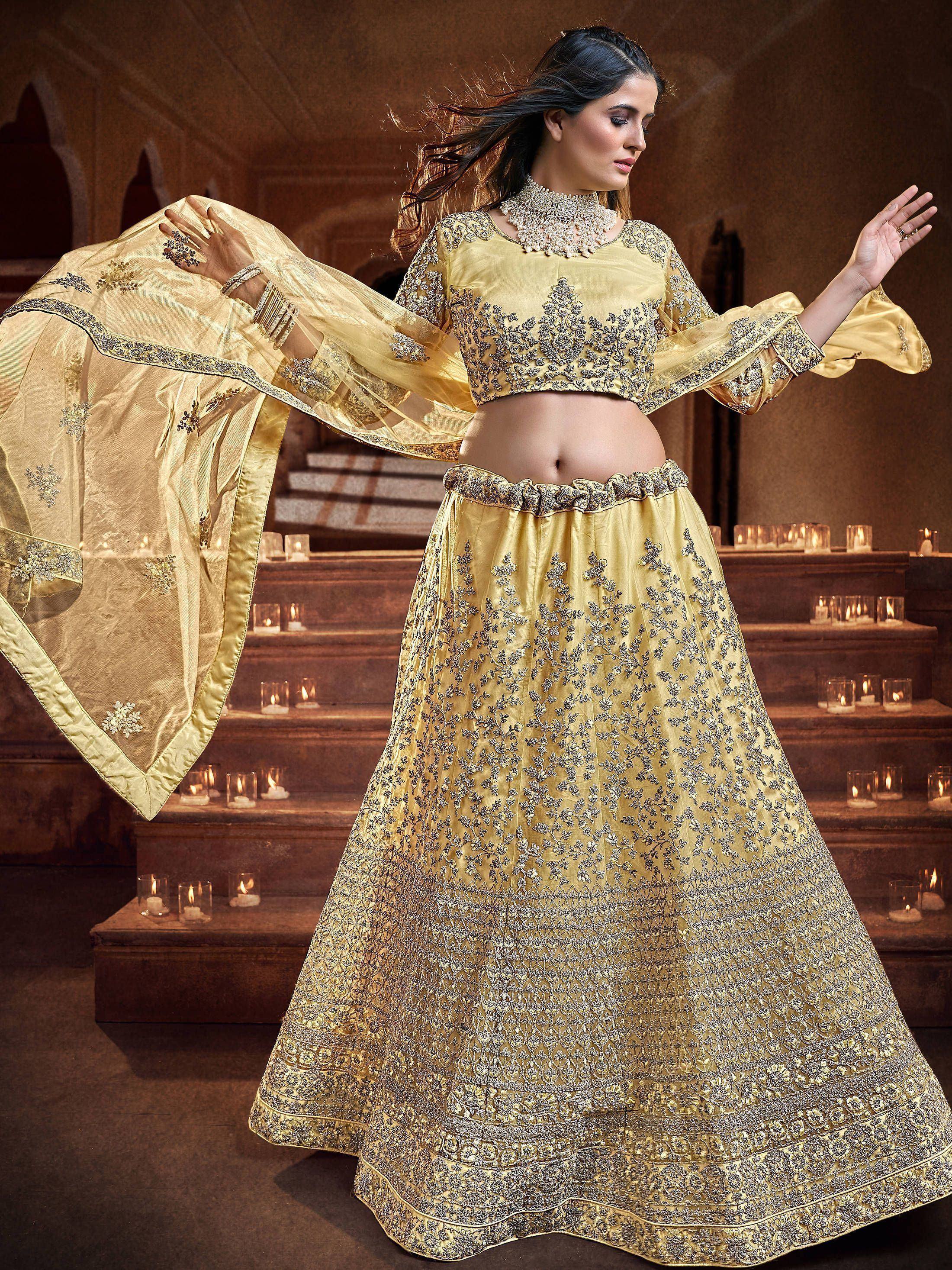 Golden embroidered lehenga choli with sheer dupatta, perfect for Indian weddings and festive occasions.