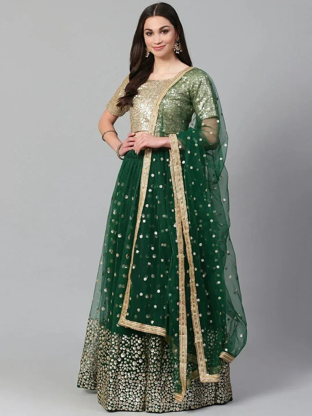 Emerald green lehenga choli with gold sequin work and sheer dupatta, perfect for Indian ethnic occasions.