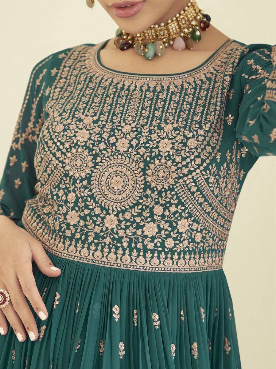 Green ethnic gown with intricate gold floral embroidery and gemstone choker necklace