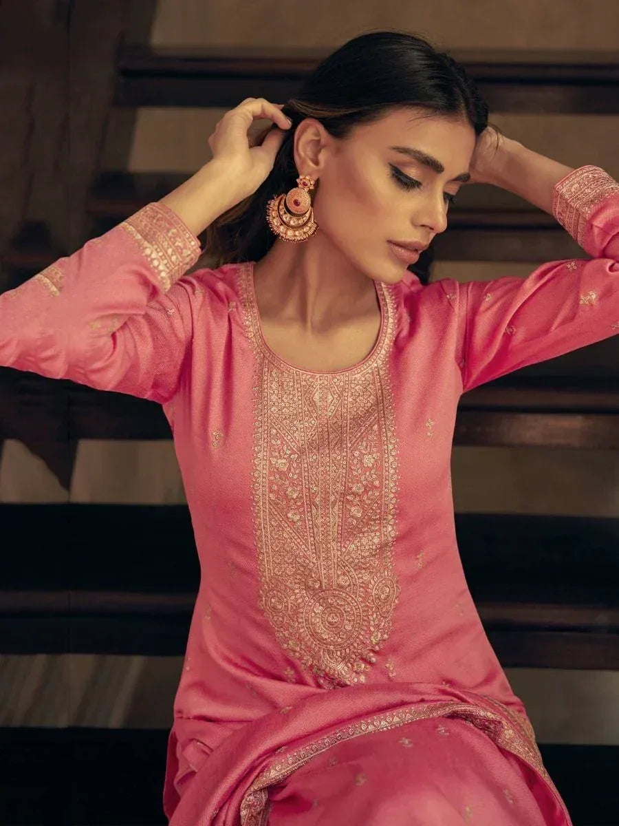 Pink embroidered ethnic kurta with gold detailing, styled with traditional jhumka earrings
