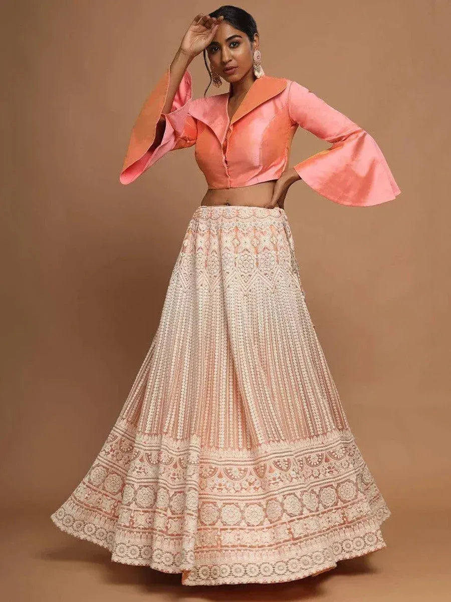 Peach designer lehenga choli with bell sleeves and intricate embroidery, perfect for Indian ethnic wear occasions.