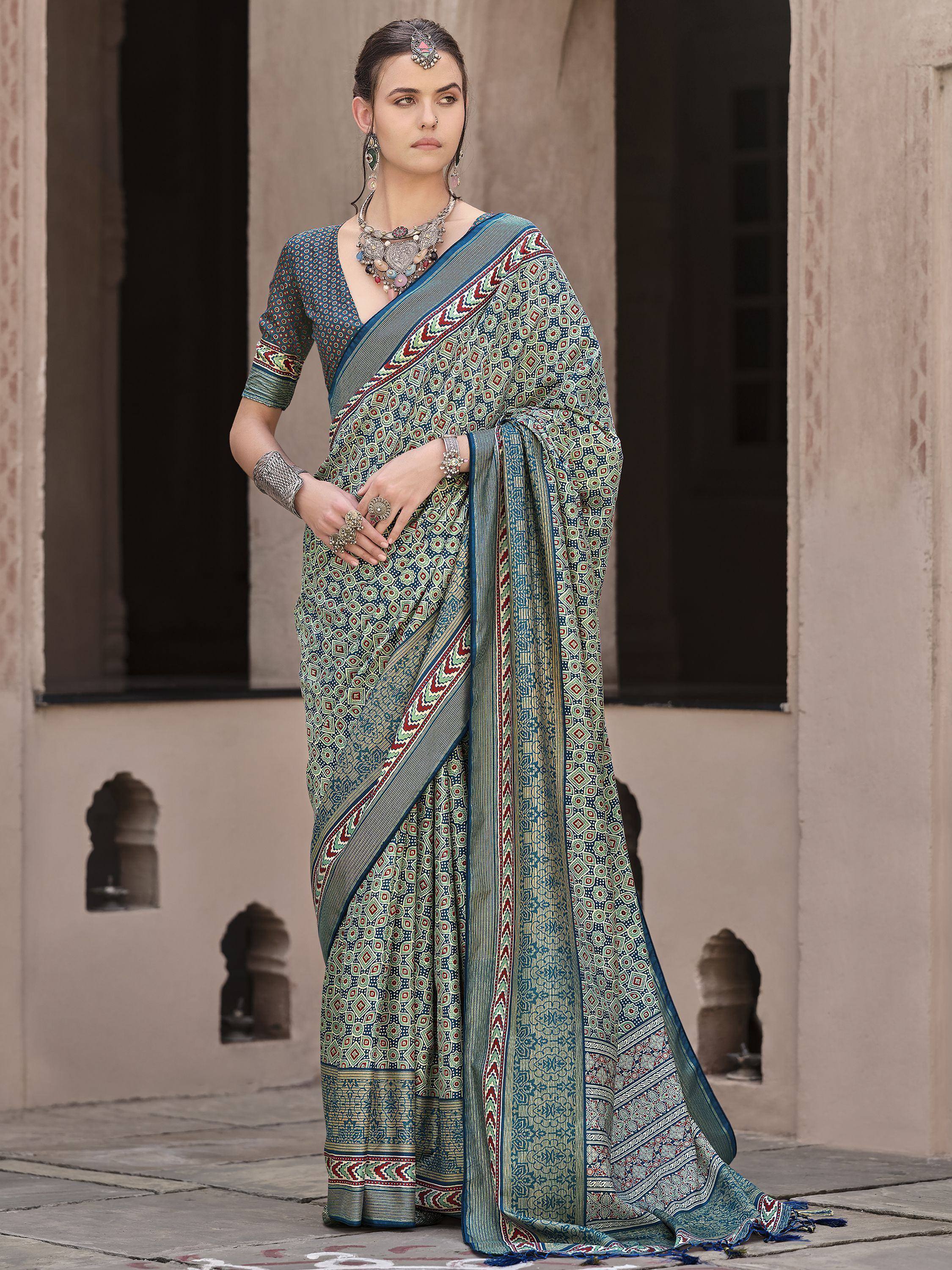 Woman in blue green printed saree with ethnic jewelry, traditional Indian wear for festive occasions