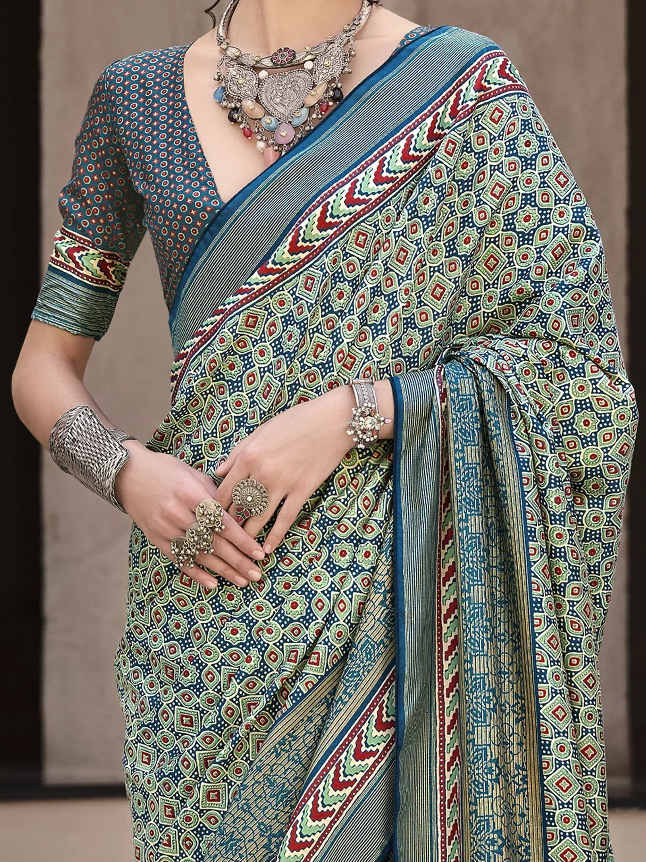 Blue green printed saree with ethnic jewelry, perfect for Indian ethnic wear occasions