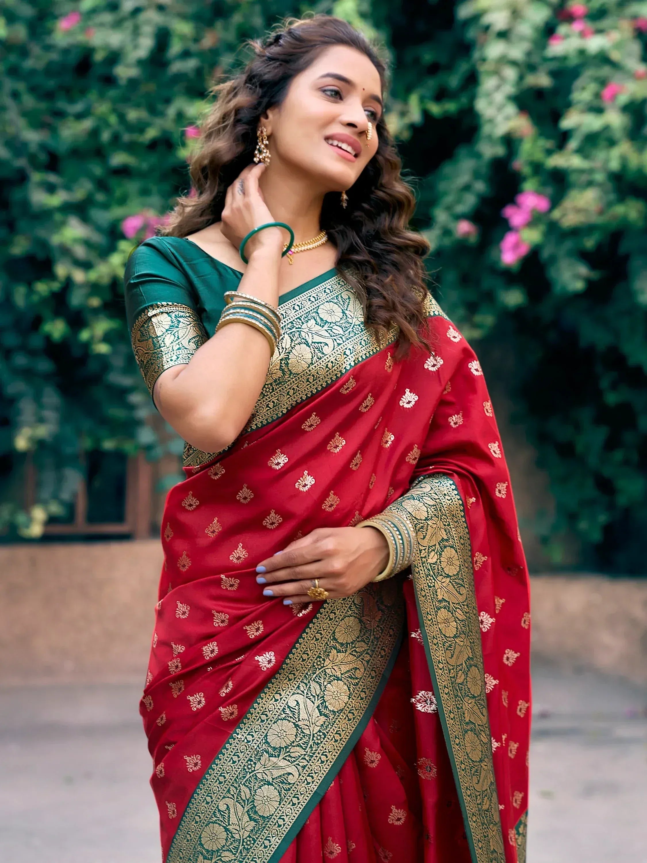 Woman in red and green designer saree with gold embroidery, perfect for Indian ethnic wear occasions