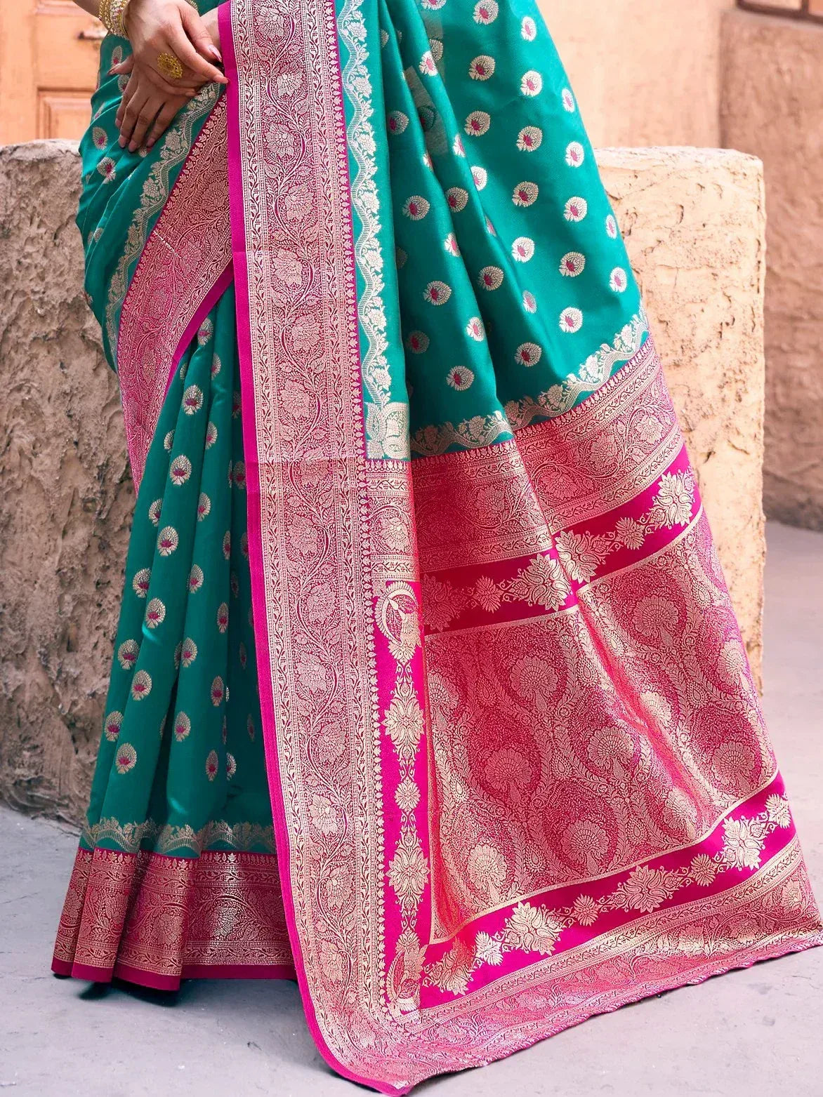 Teal and pink designer saree with gold floral motifs and intricate border, ideal for Indian ethnic wear