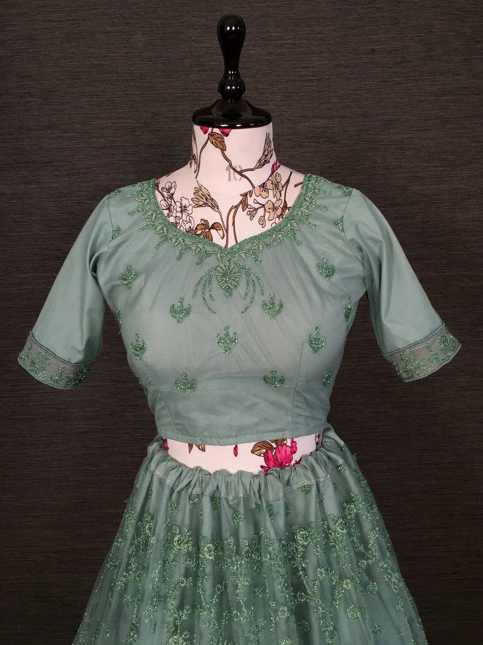 Mint green embroidered lehenga choli with floral embellishments, perfect for Indian ethnic wear occasions.