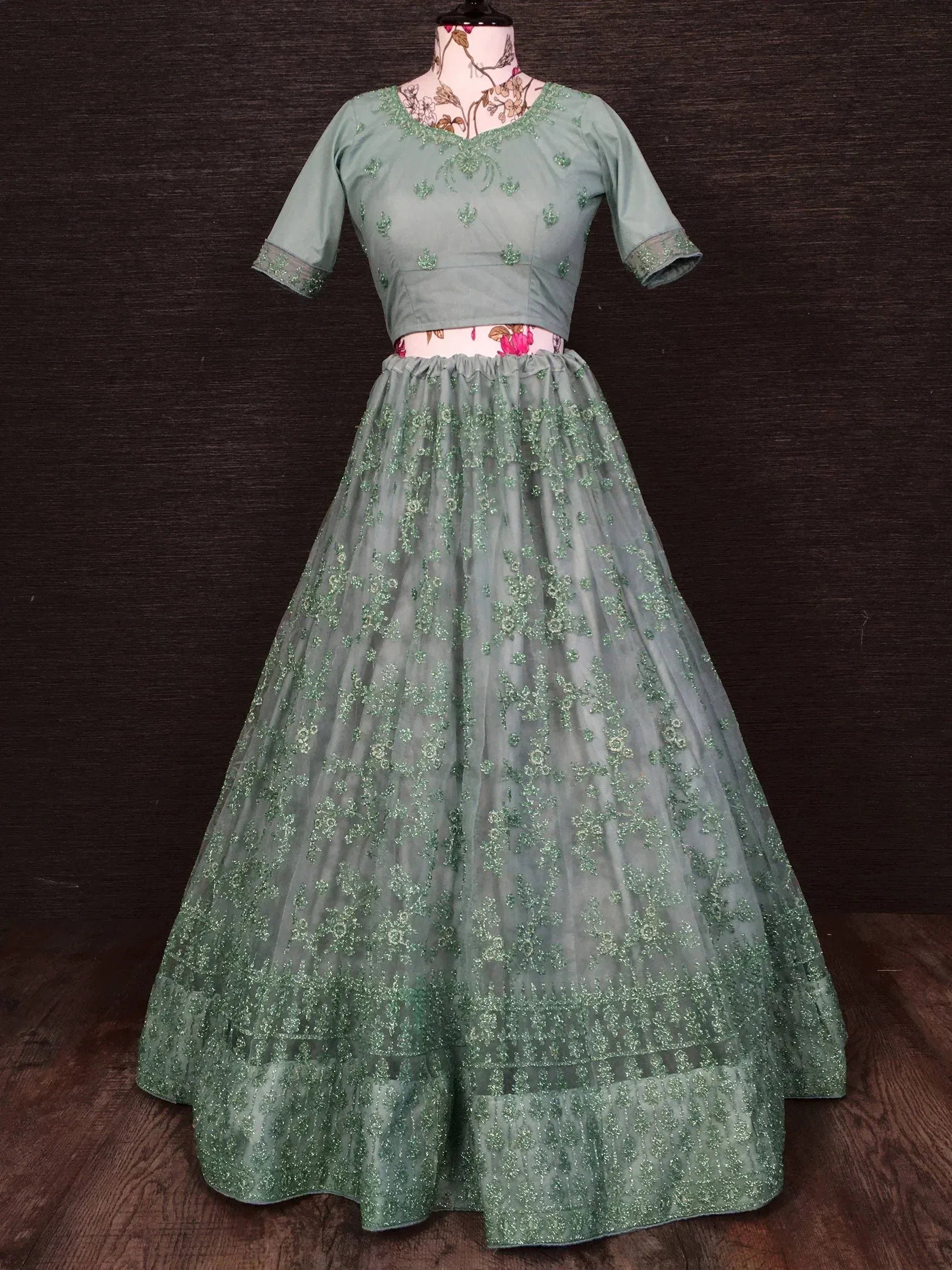 Mint green embroidered lehenga choli with floral embellishments, perfect for Indian ethnic wear occasions.