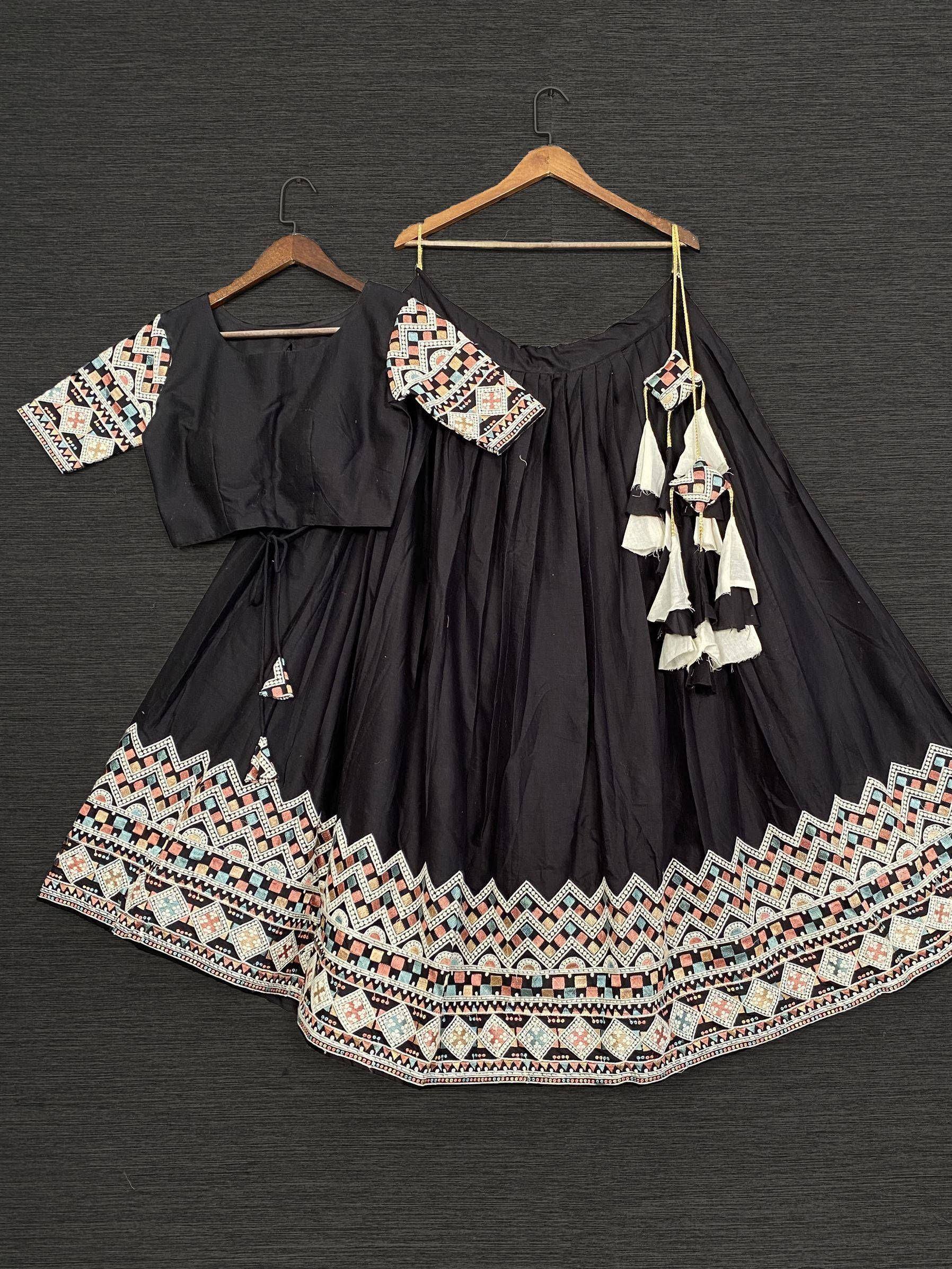 Black ethnic lehenga choli with colorful geometric embroidery and tassel details, perfect for festive occasions.