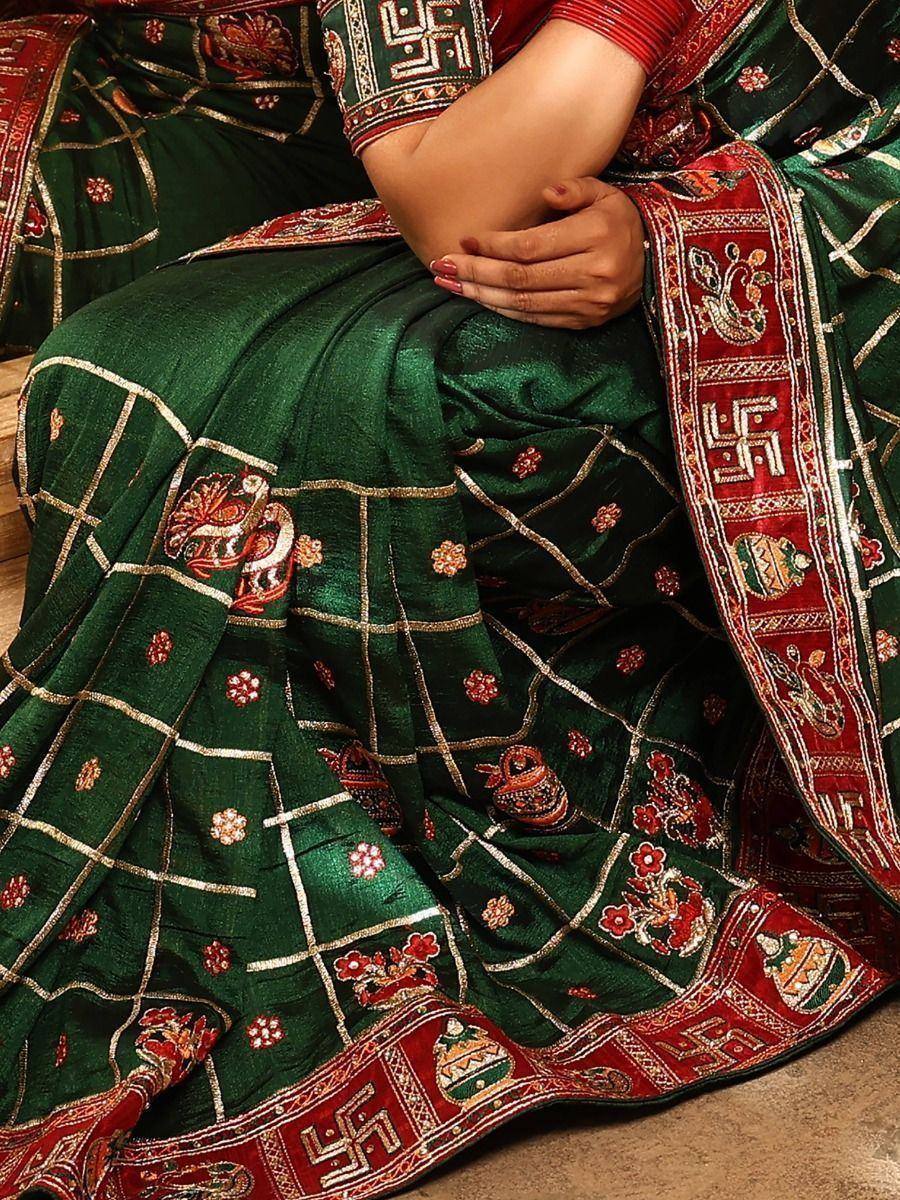Green ethnic saree with red border, gold embroidery, and traditional motifs for festive occasions