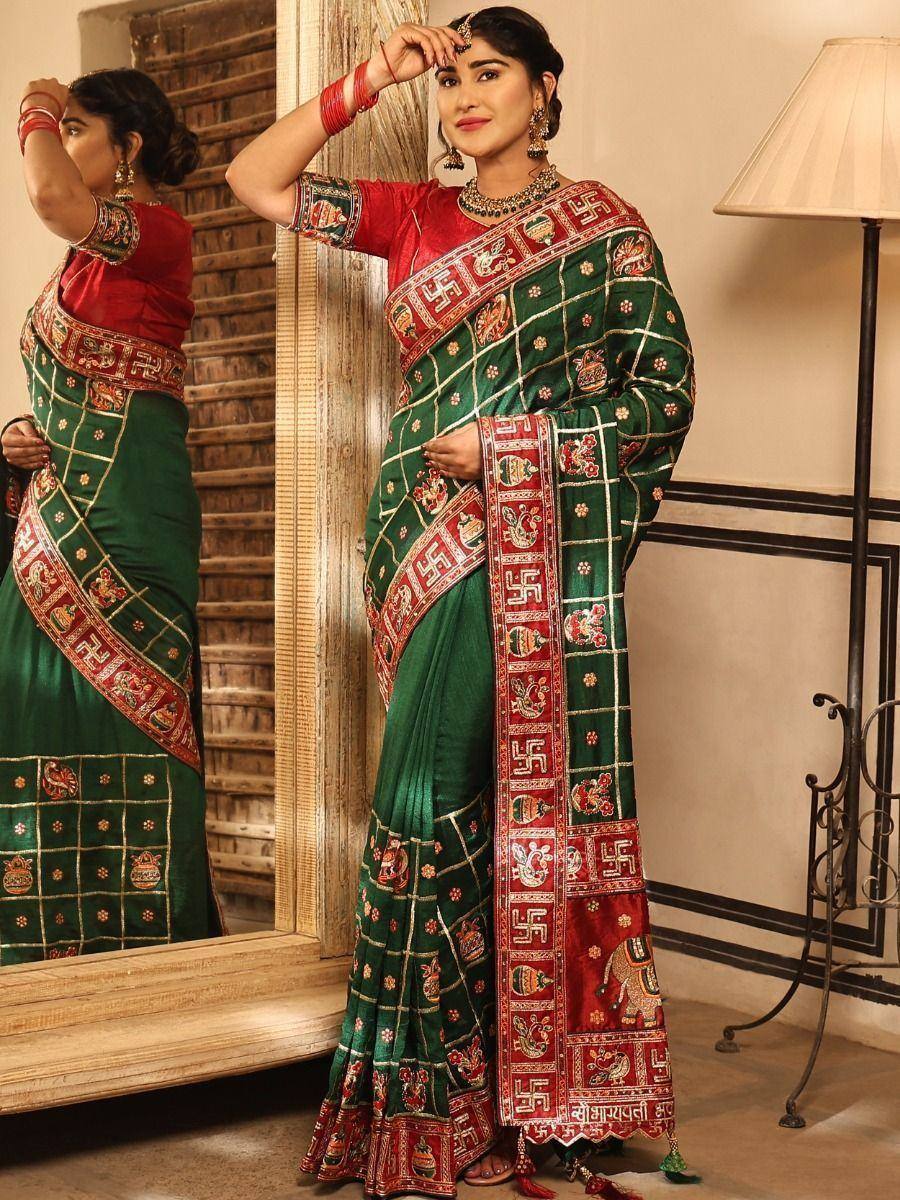 Green and red embroidered saree with traditional motifs and border designs