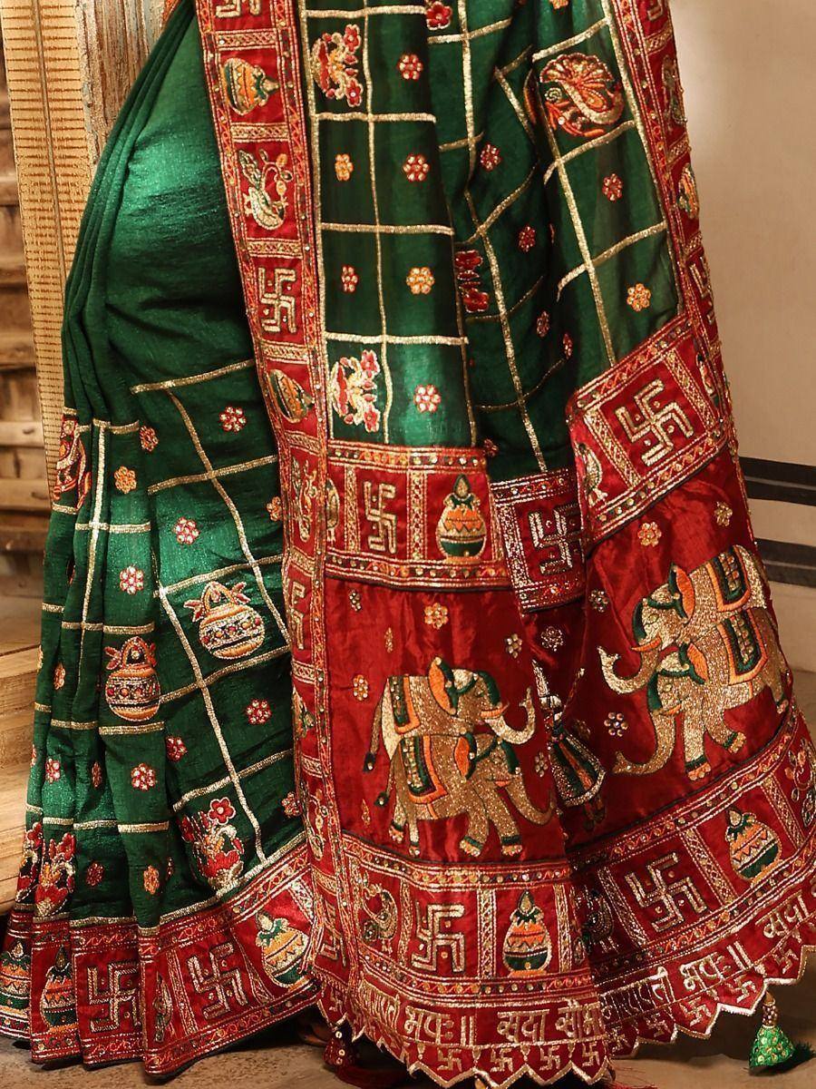 Green and red ethnic saree with elephant and swastika motifs, traditional Indian wedding wear