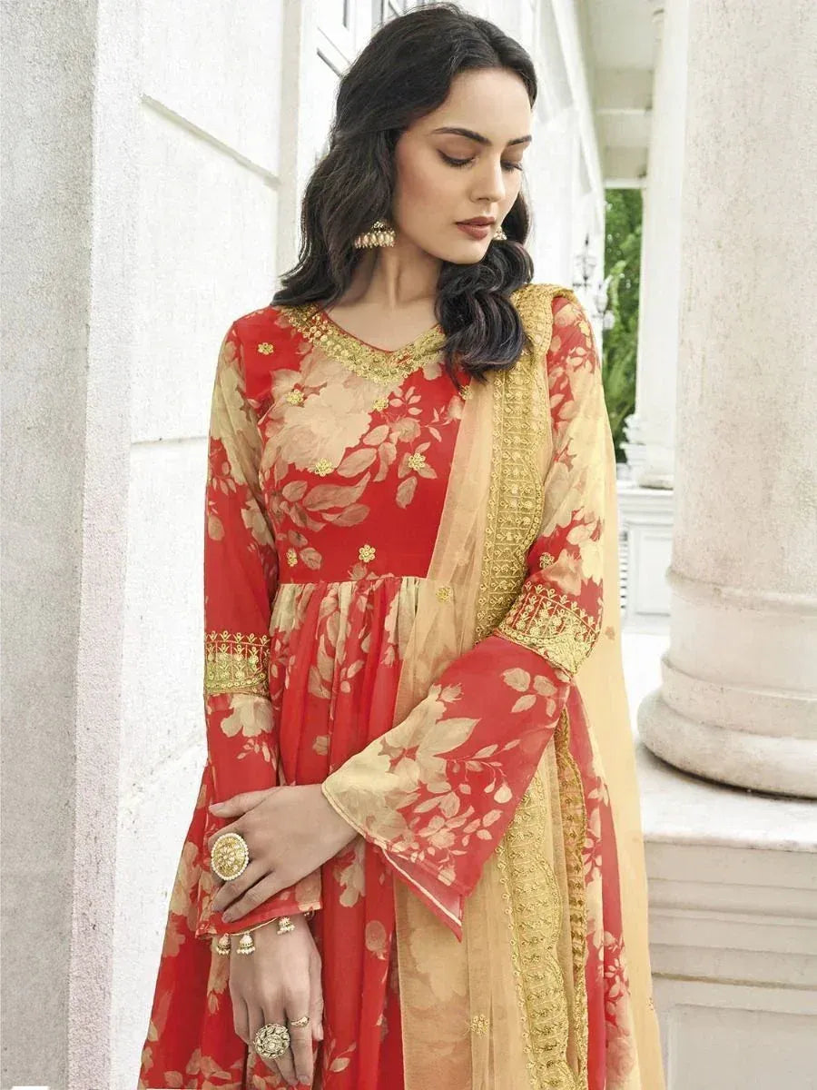 Woman wearing red and beige floral Indian ethnic gown with gold embroidery details