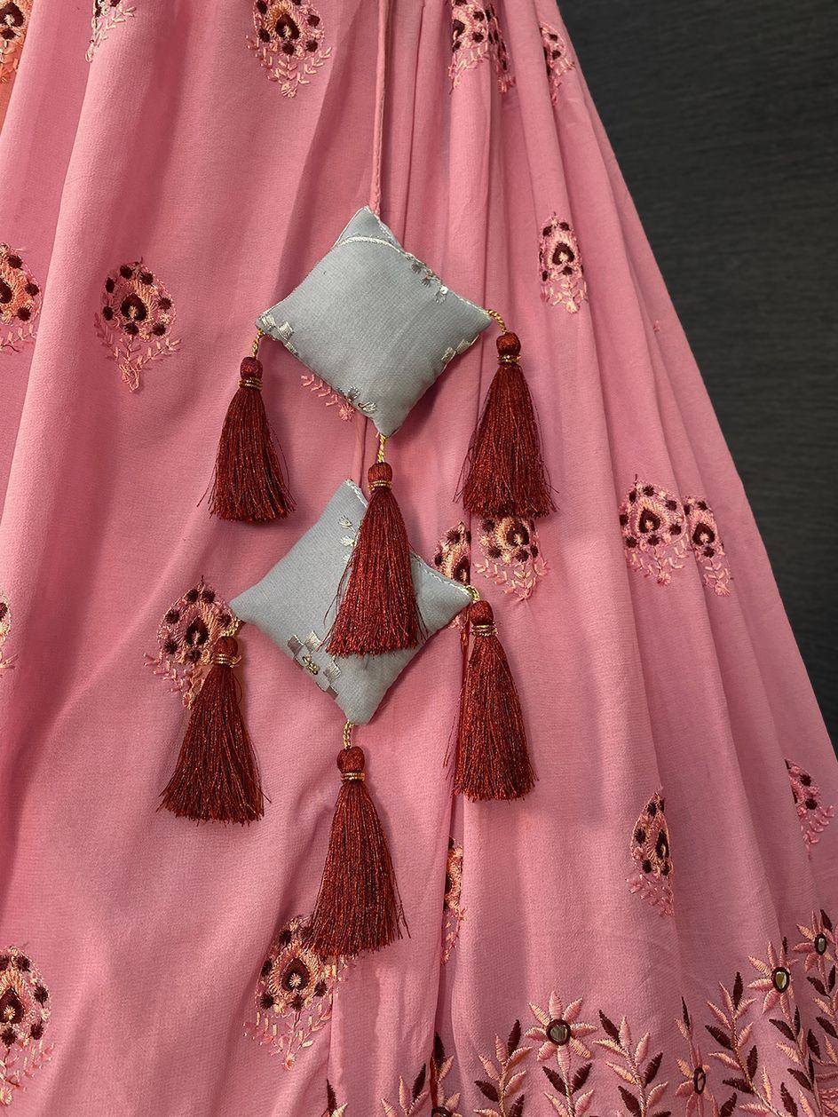 Pink embroidered lehenga with tassels and decorative cushions, Indian ethnic wear