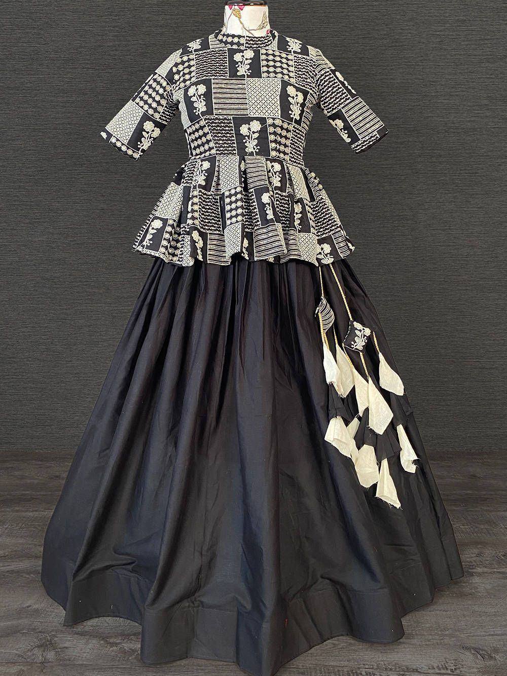 Black and white embroidered ethnic gown with patchwork top and tassel detailing, perfect for Indian occasions.