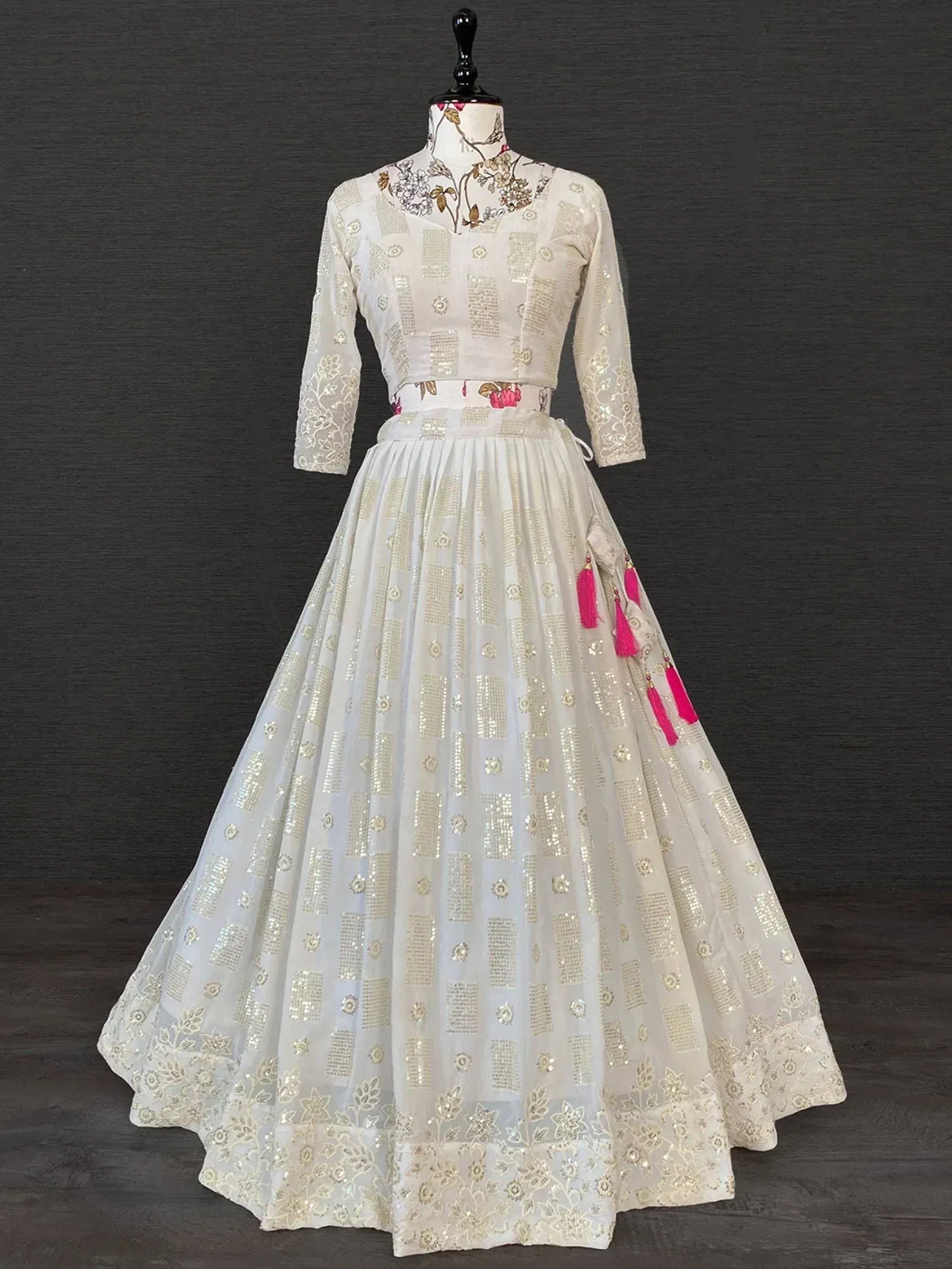 White embroidered lehenga choli with gold sequins and pink tassels, Indian ethnic wear for women