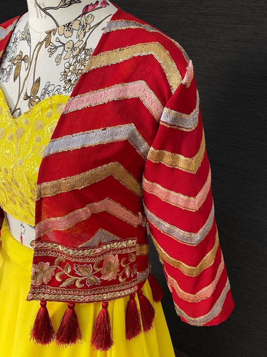 Red embroidered jacket with gold stripes and tassels over yellow lehenga choli, Indian ethnic wear
