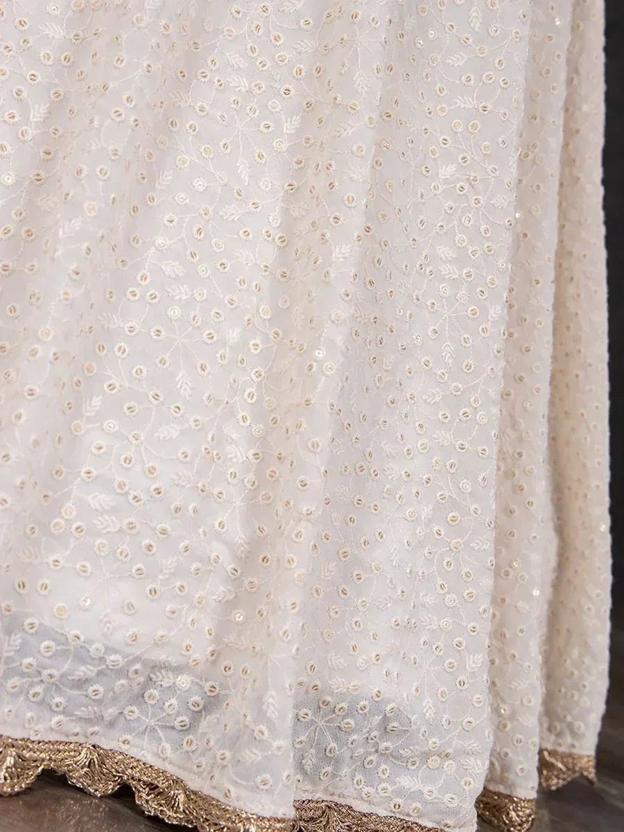 White ethnic gown with gold floral embroidery and scalloped hem, perfect for Indian occasions.