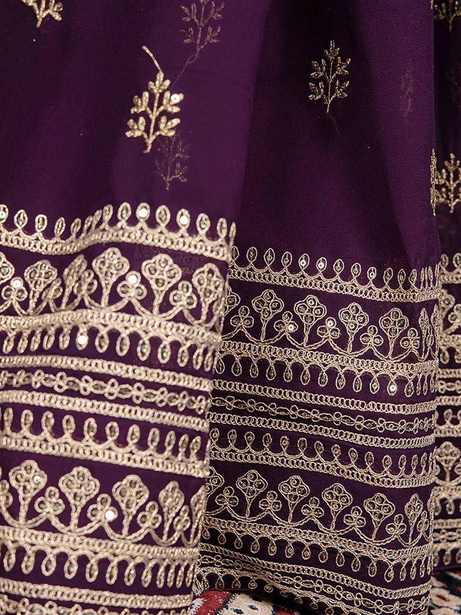 Purple ethnic wear with gold embroidery and mirror work, perfect for festive occasions.