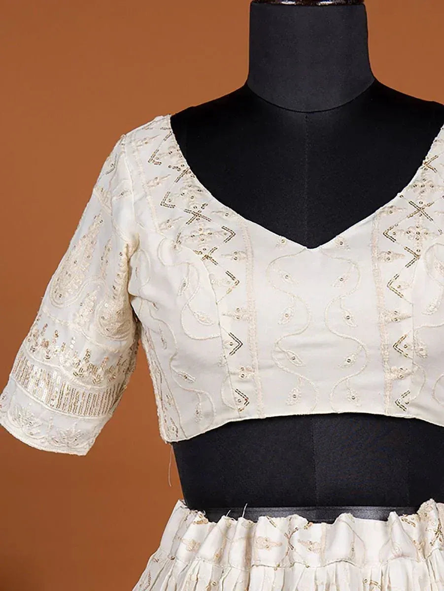 Cream embroidered lehenga choli top with gold threadwork and V-neck design