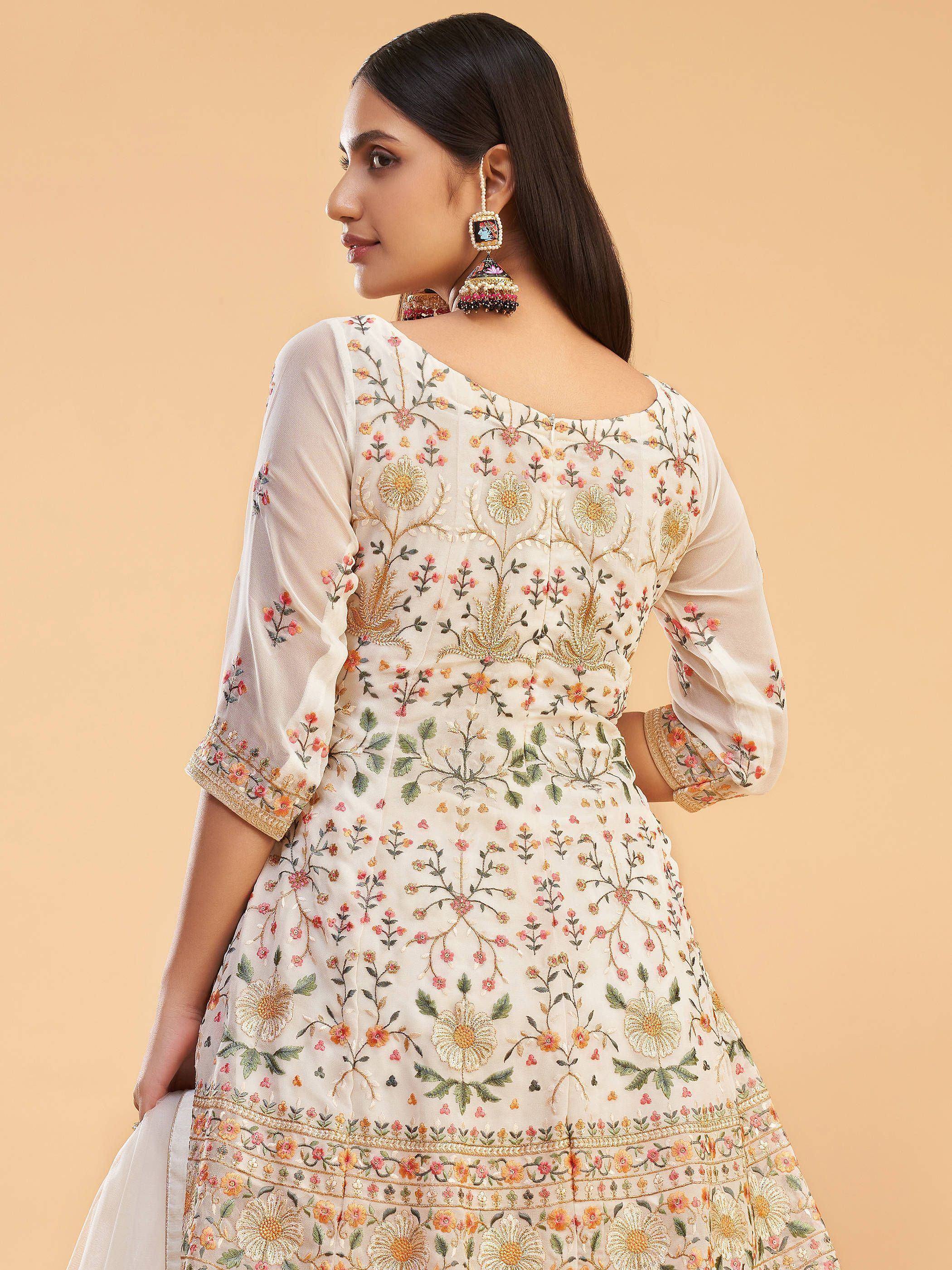 Elegant floral embroidered ethnic gown with intricate detailing and stylish jhumka earrings