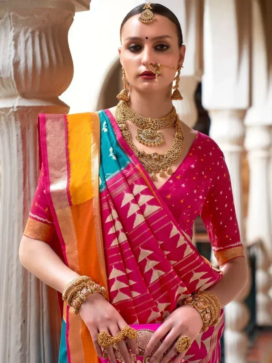 Vibrant pink and teal ethnic saree with gold jewelry, perfect for Indian weddings and festive occasions.