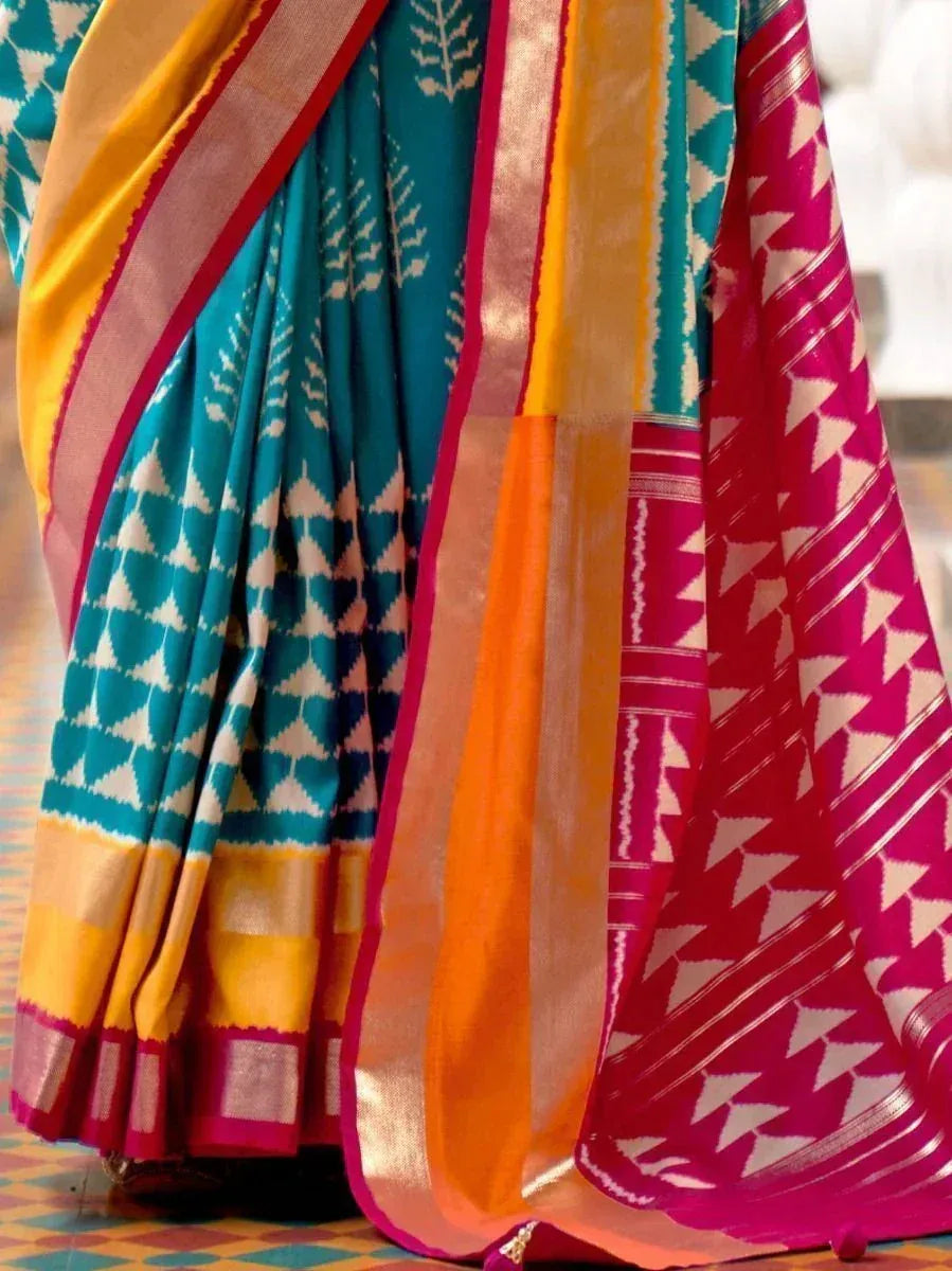 Vibrant teal and magenta ikat saree with geometric patterns, perfect for Indian ethnic wear occasions