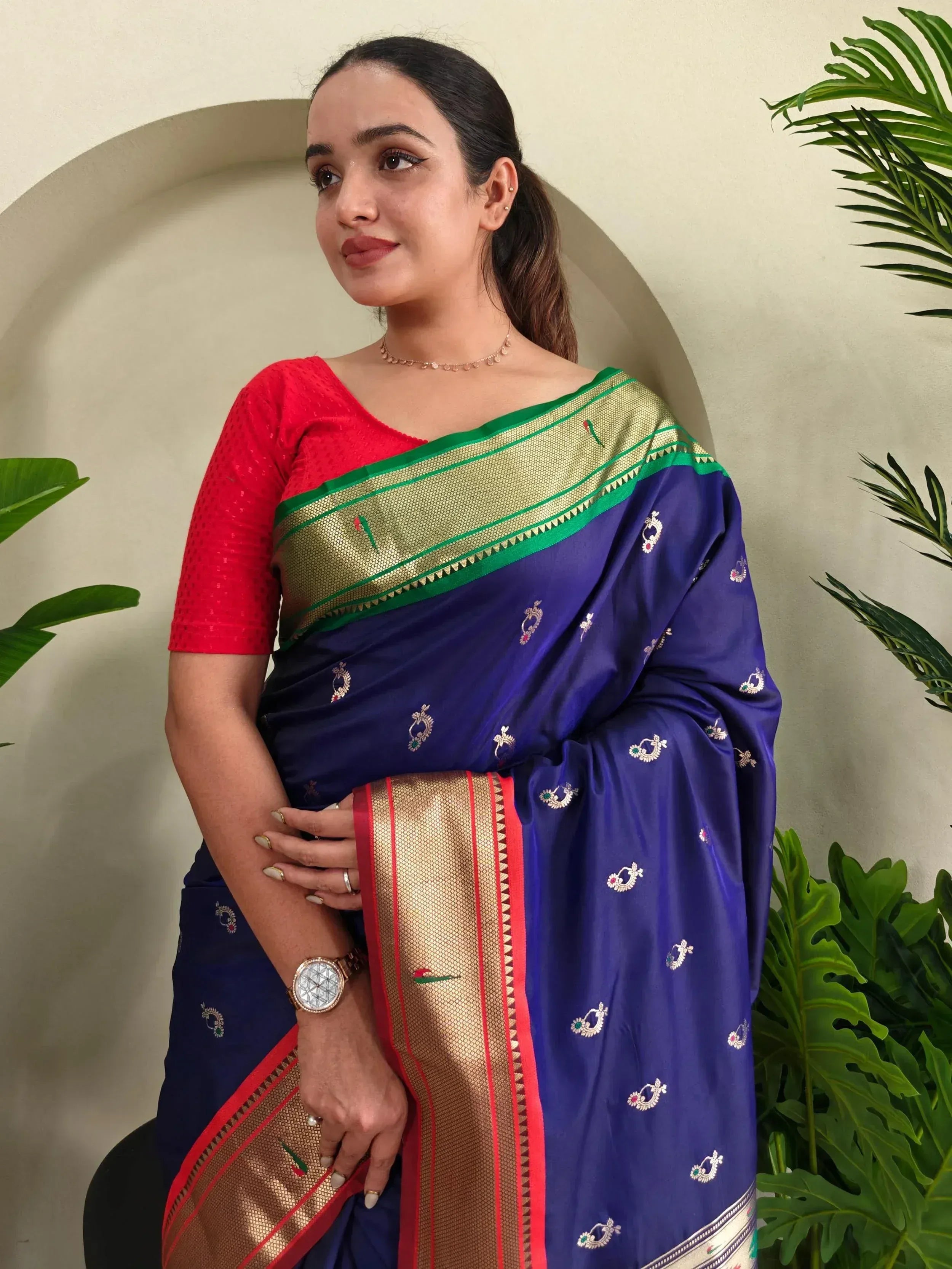 Woman in royal blue embroidered saree with gold border and red blouse, Indian ethnic wear