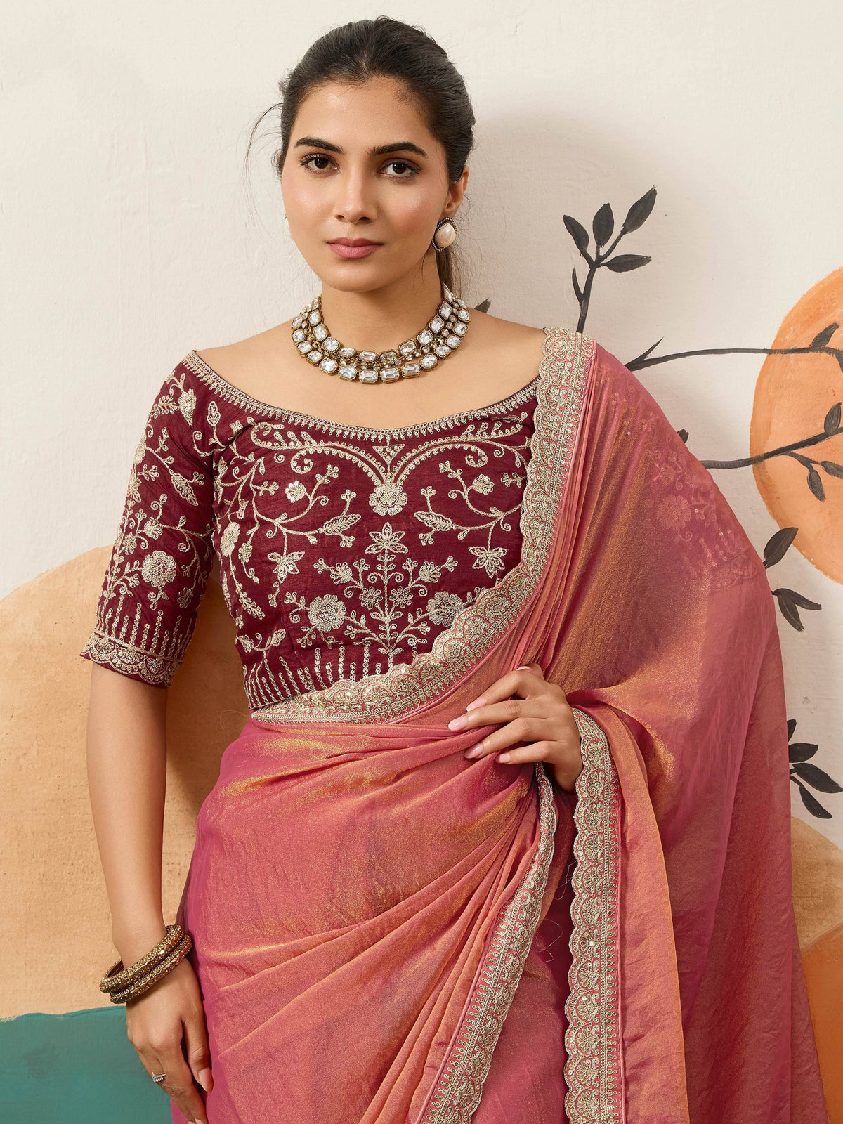 Elegant maroon embroidered blouse with pink saree, perfect for Indian ethnic wear occasions.