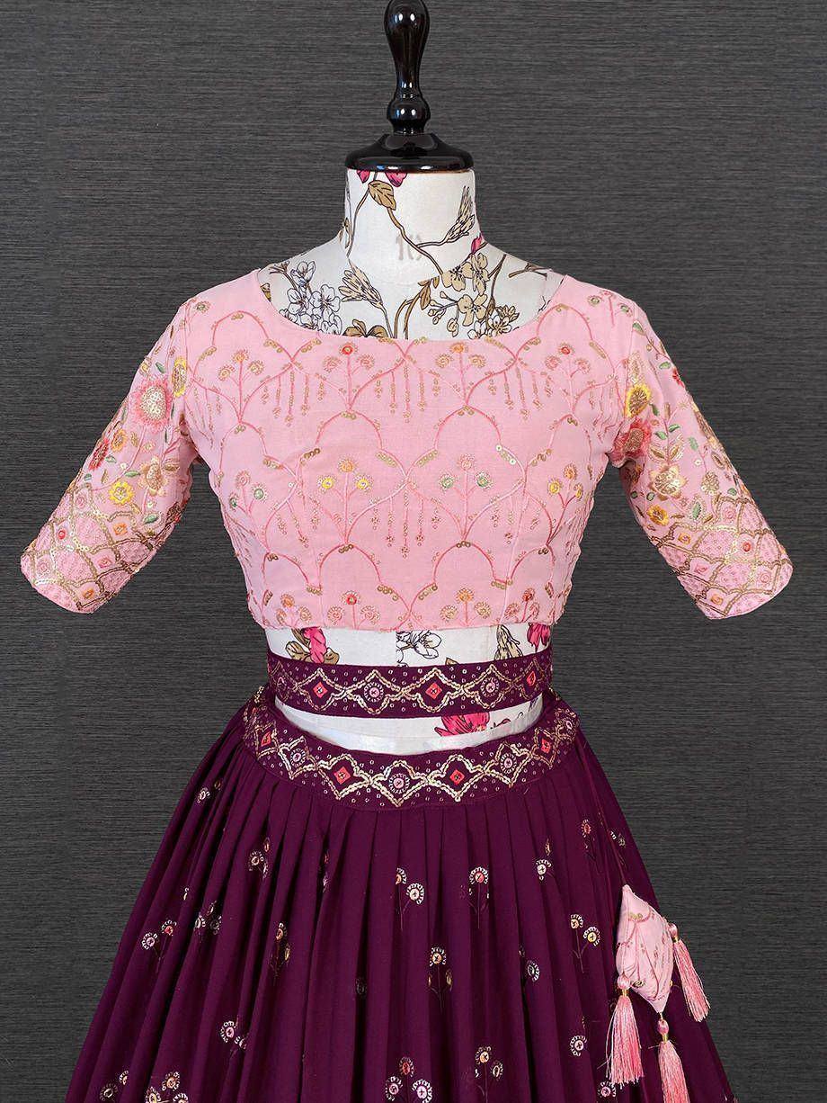 Pink embroidered blouse with maroon lehenga, floral motifs, and tassels for Indian ethnic wear